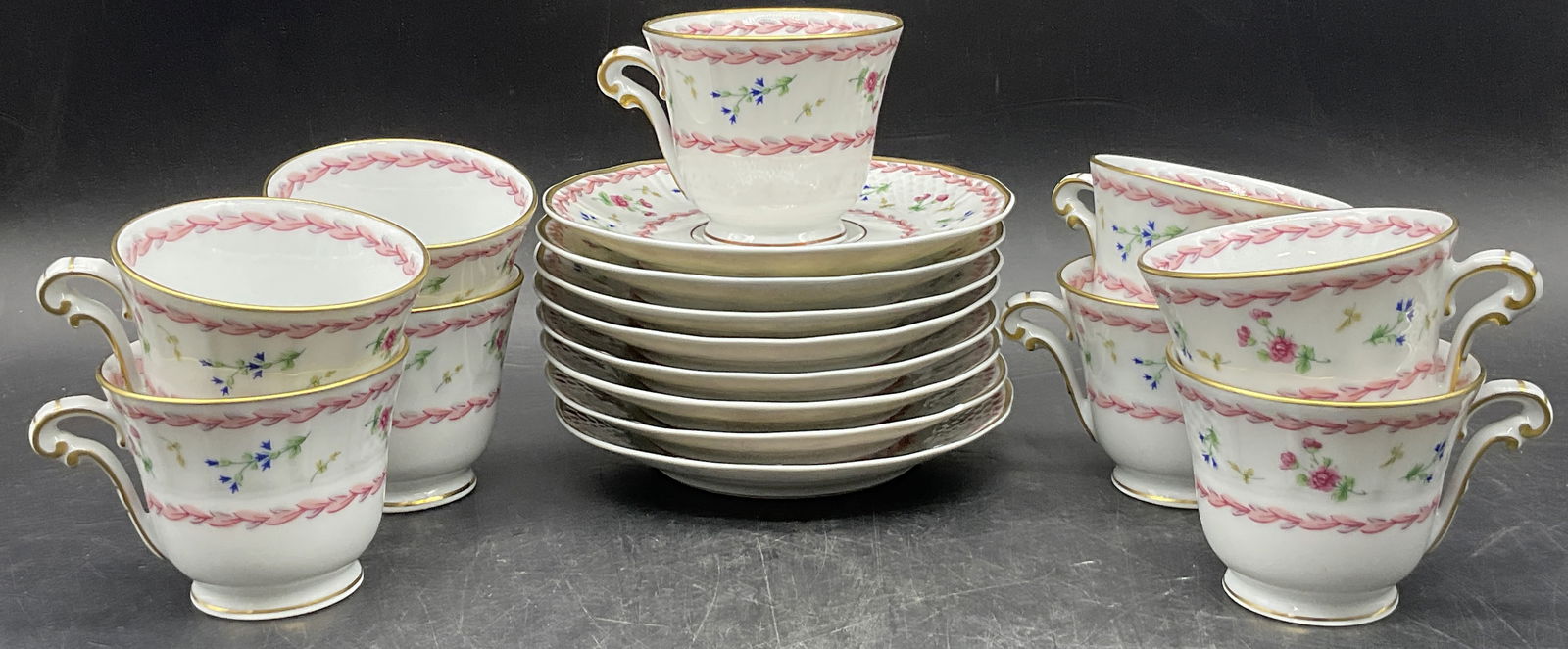 Set 17pcs BERNARDAUD LIMOGES FRANCE ARTOIS ROSE: Nine porcelain demitasse cups and eight porcelain saucers. Signed BERNARDAUD LIMOGES FRANCE ARTOIS ROSE. Saucers measure approx. 5L x 5W in. Surface wear, chipping, discoloration, and residue present.