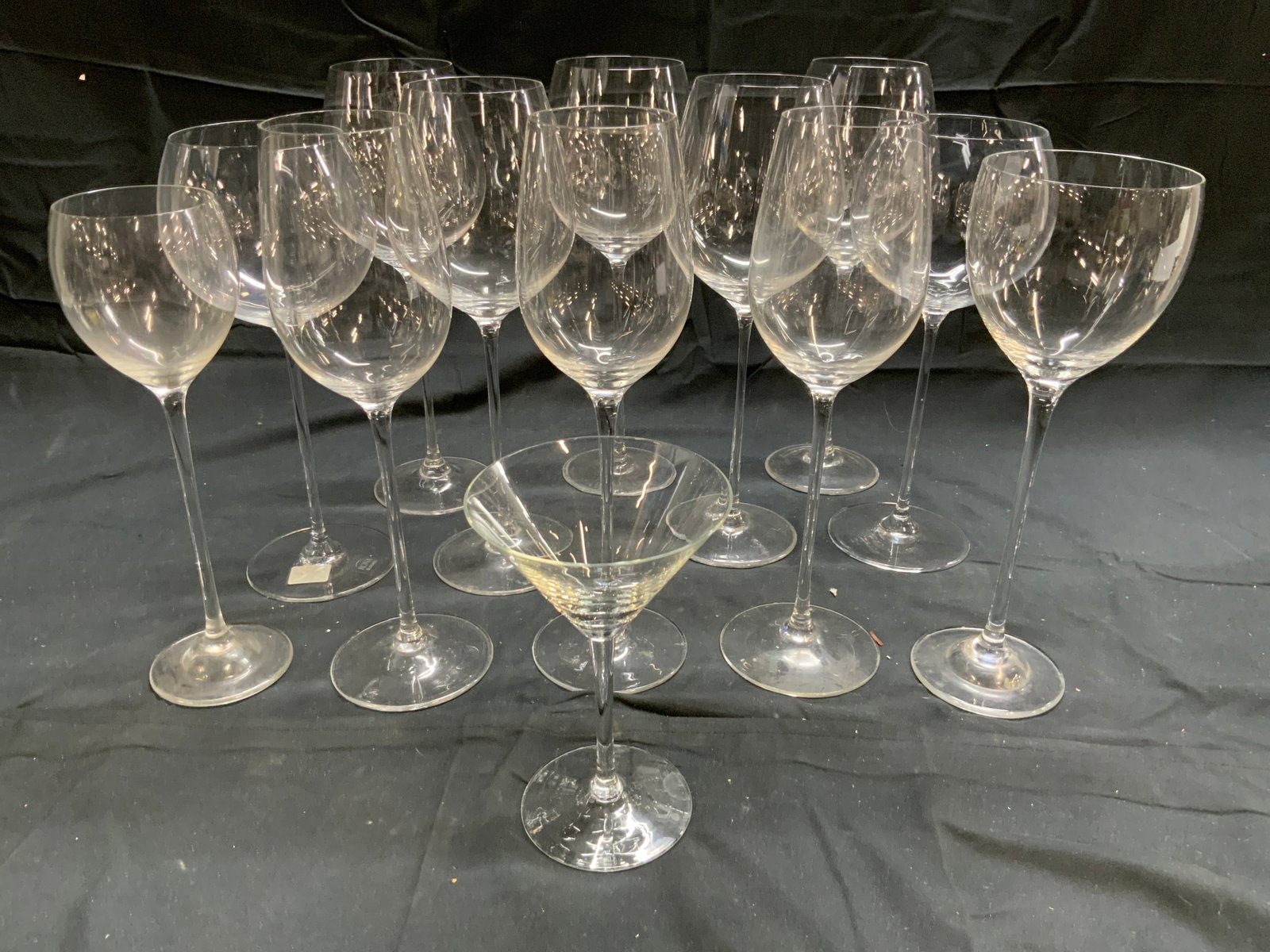 Lot 13 Wine & Cocktail Glasses RONA & More: One glass is trademarked RONA SLOVAKIA. Lot includes 1 martini glass & 12 variously sized wine glasses. Each piece appears to be crystal. Largest glasses measure approximately 11 inches tall 4 inches 