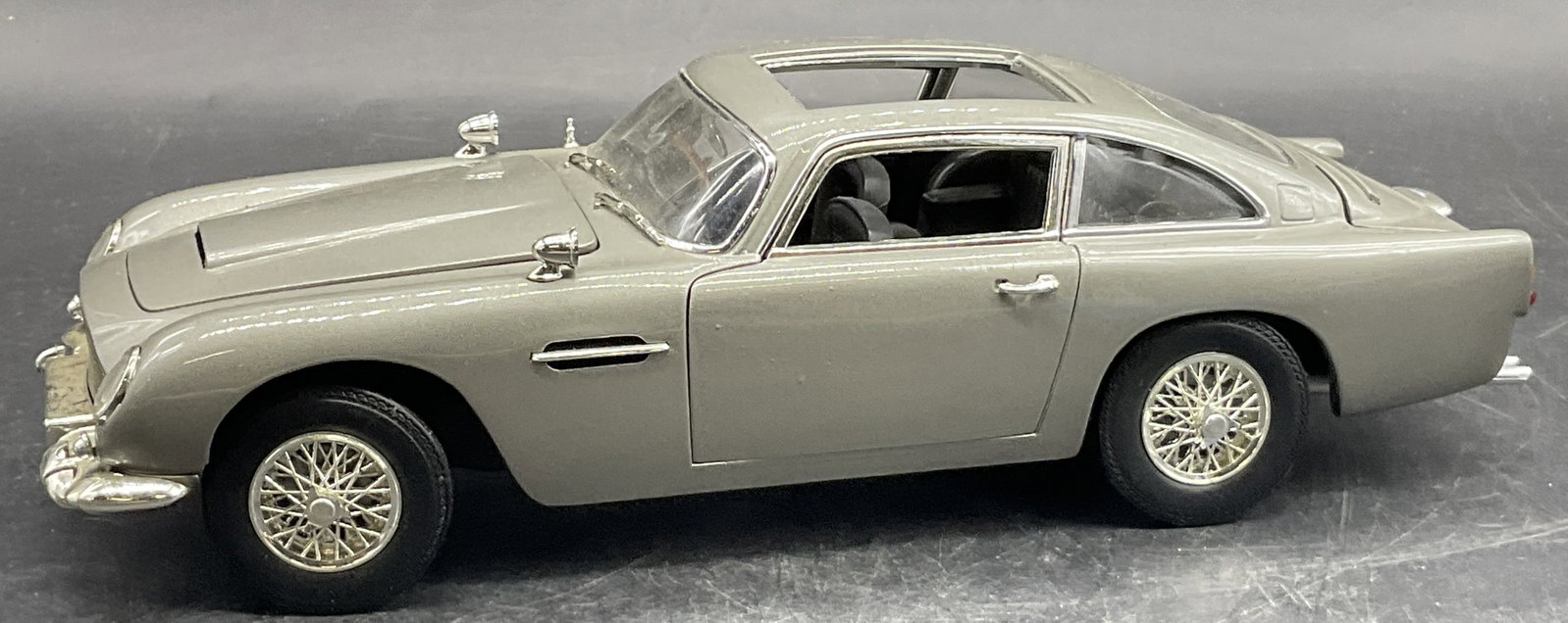 2004 ASTON MARTIN LAGONDA Joyride Studios Model: 2004 ASTON MARTIN LAGONDA Joyride Studios Model Car. Measures approx. 3H x 10W in. Moveable pieces. Underside reads 2004 ASTON MARTIN LAGONDA Joyride Studios. Loose pieces. Crafted from metal and plas