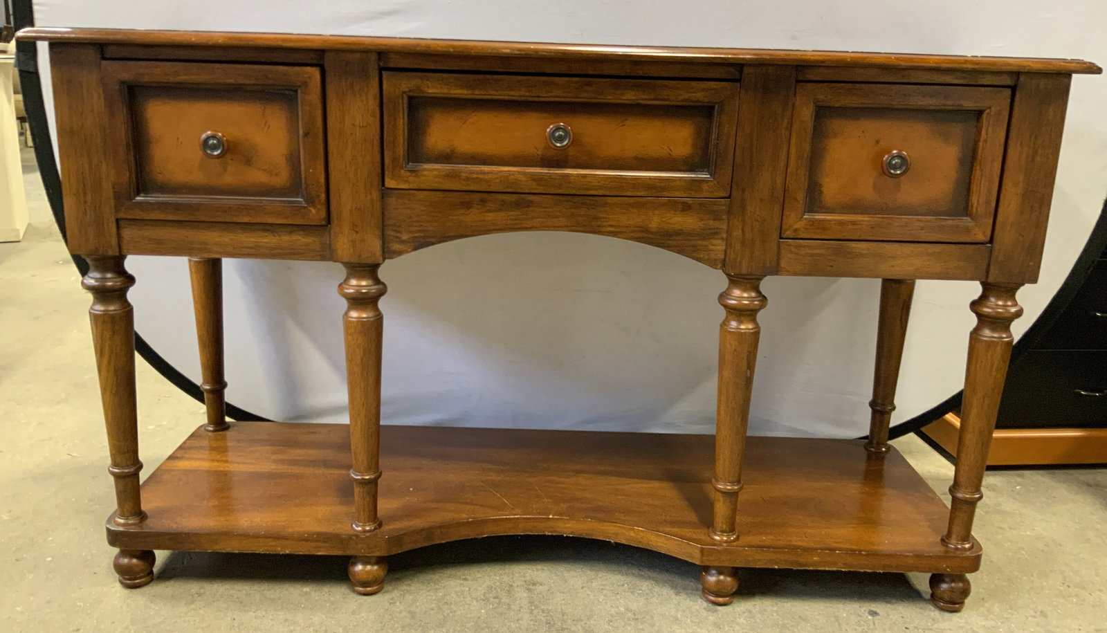 Vintage 3 Drawer Wooden Sideboard: Sideboard is vintage and wooden. Piece is tan toned. Piece has 6 carved wooden legs & feet. Sideboard has 3 drawers. Each drawer has knob form handles. Measures approximately 54 inches long 33 inches 