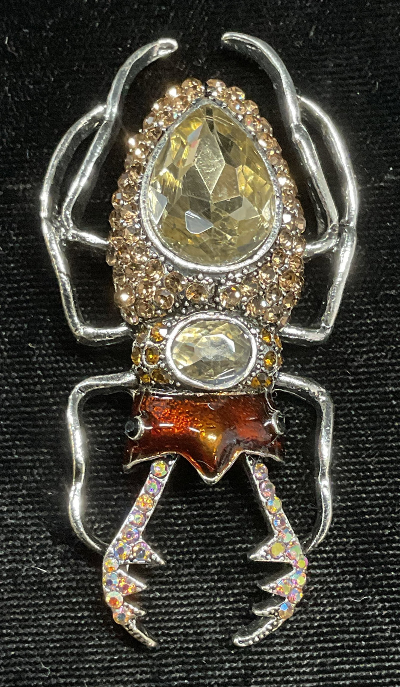 Silver Tn Crystal Enamel Beetle Brooch: Silver tone beetle motif brooch with crystal and enamel decoration. Hinge pin on underside. Measures approx 2.75 x 1.25 inches. Some wear including scratching observed. Jewelry, estate jewelry, costum