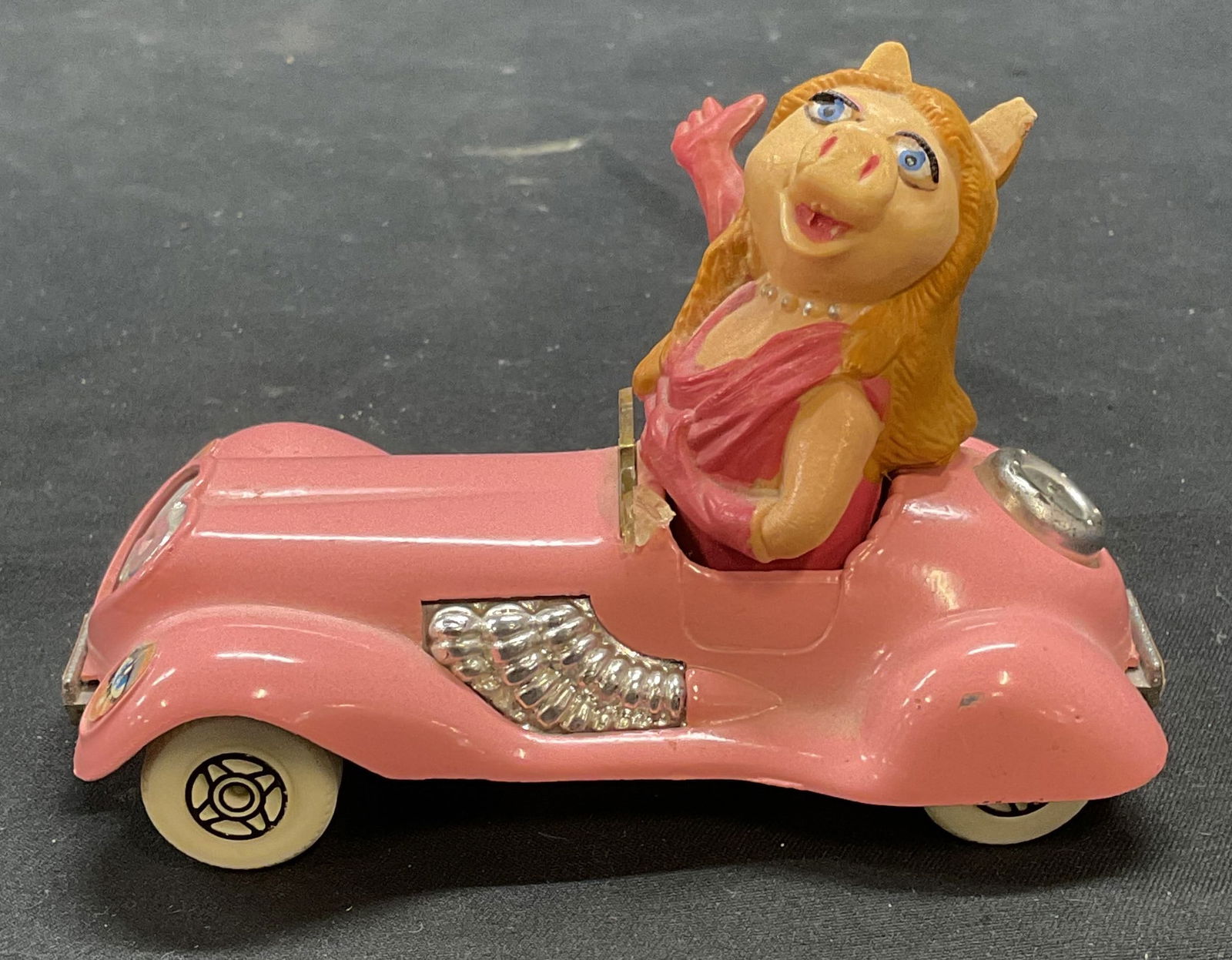 1979 Corgi Henson Assoc Miss Piggy Toy Car: Vintage 1979 Corgi Henson Associates Miss Piggy pink toy car. Signed on underside. Measures approx. 4 x 2 x 2.5 inches. Metal and plastic. Some wear consistent with exposure. Miss piggy, miss piggy ca