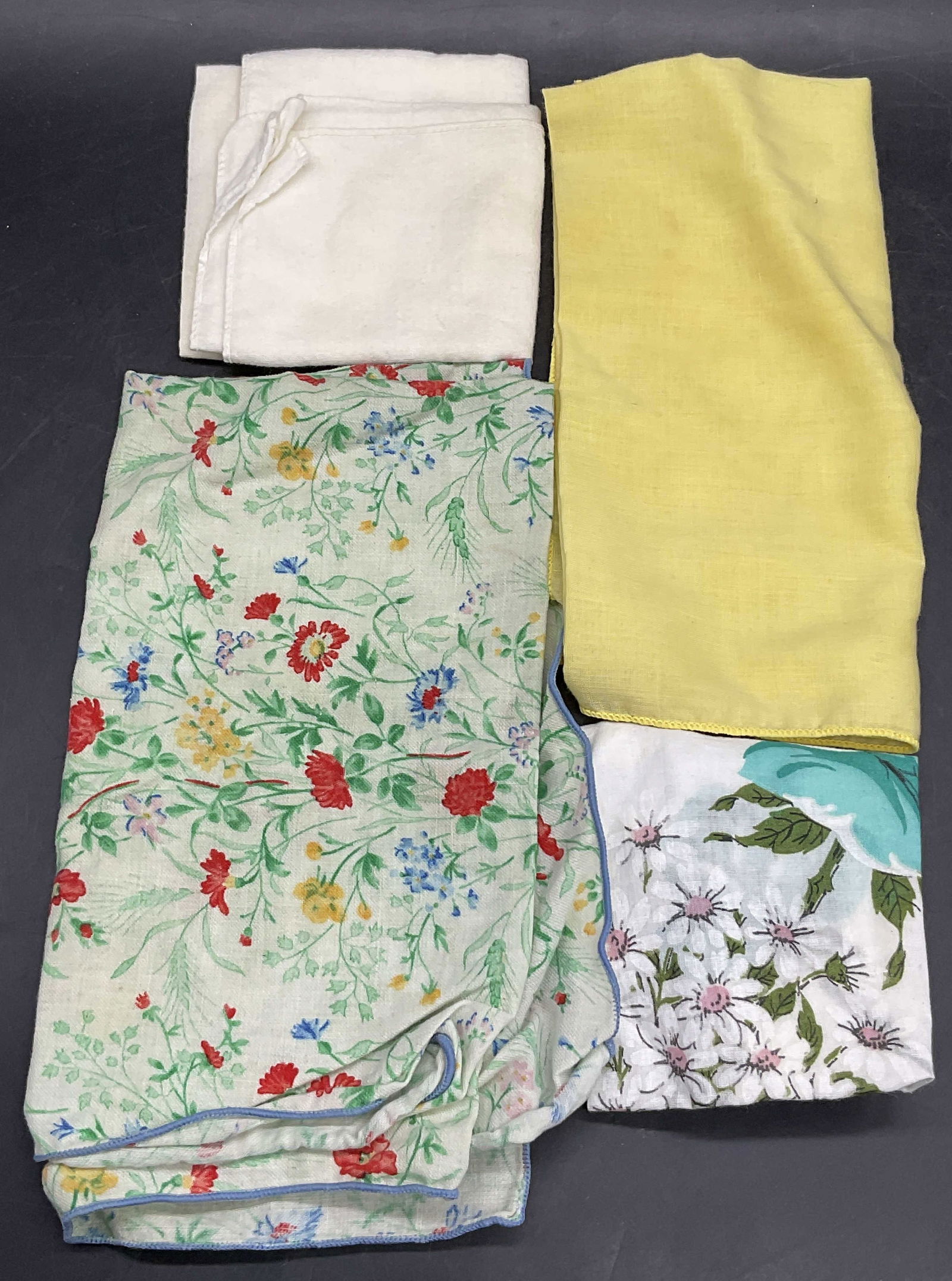 Lot 4 Vintage Fabric Handkerchiefs, Floral +: Four Vintage Fabric Handkerchiefs. Solid colors or floral patterns to the pieces. Crafted from soft hand fabric. Largest measures approx.16.5W x 18L in. Pieces have discoloration, surface wear, and ho