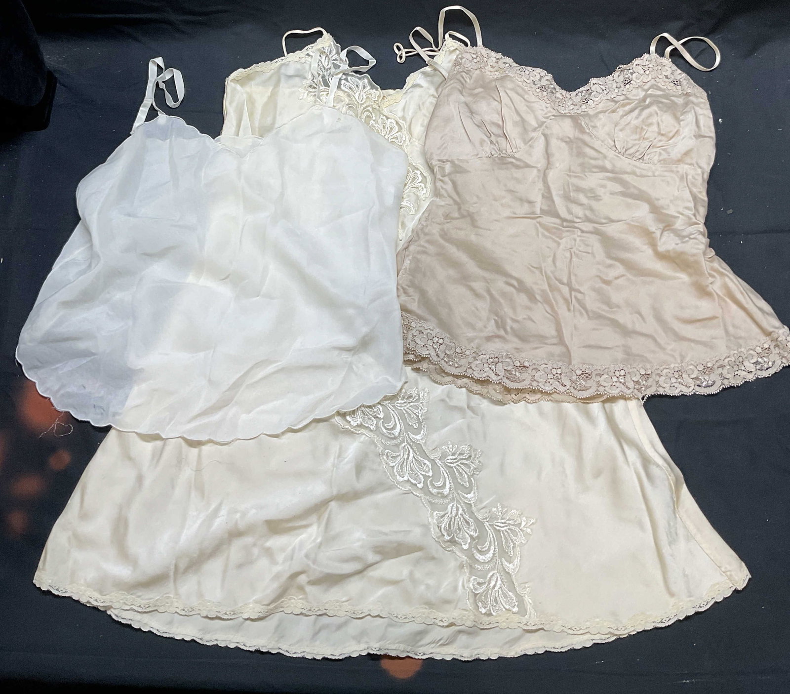 Lot 3 Tyrwhitt, Bloomingdales + Silk Camisoles: Lot of 3 camisoles and slip. Charles Tyrwhitt beige silk lace camisole, size 10. Bloomingdales white scalloped hem camisole, measures approx 17 inches across chest, synthetic material. Victorias Secre