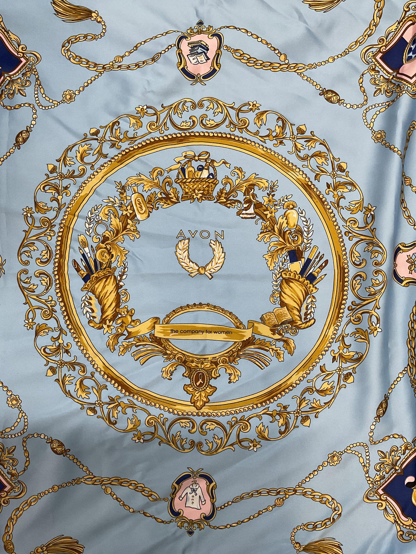 Avon The Company For Women Blue Scarf, Italy: Avon The Company for Woman scarf in blue and gold. Woman themed and scroll motifs. Made in Italy. Polyester. Some wear to material including blemishes consistent with exposure. Avon, Avon the company