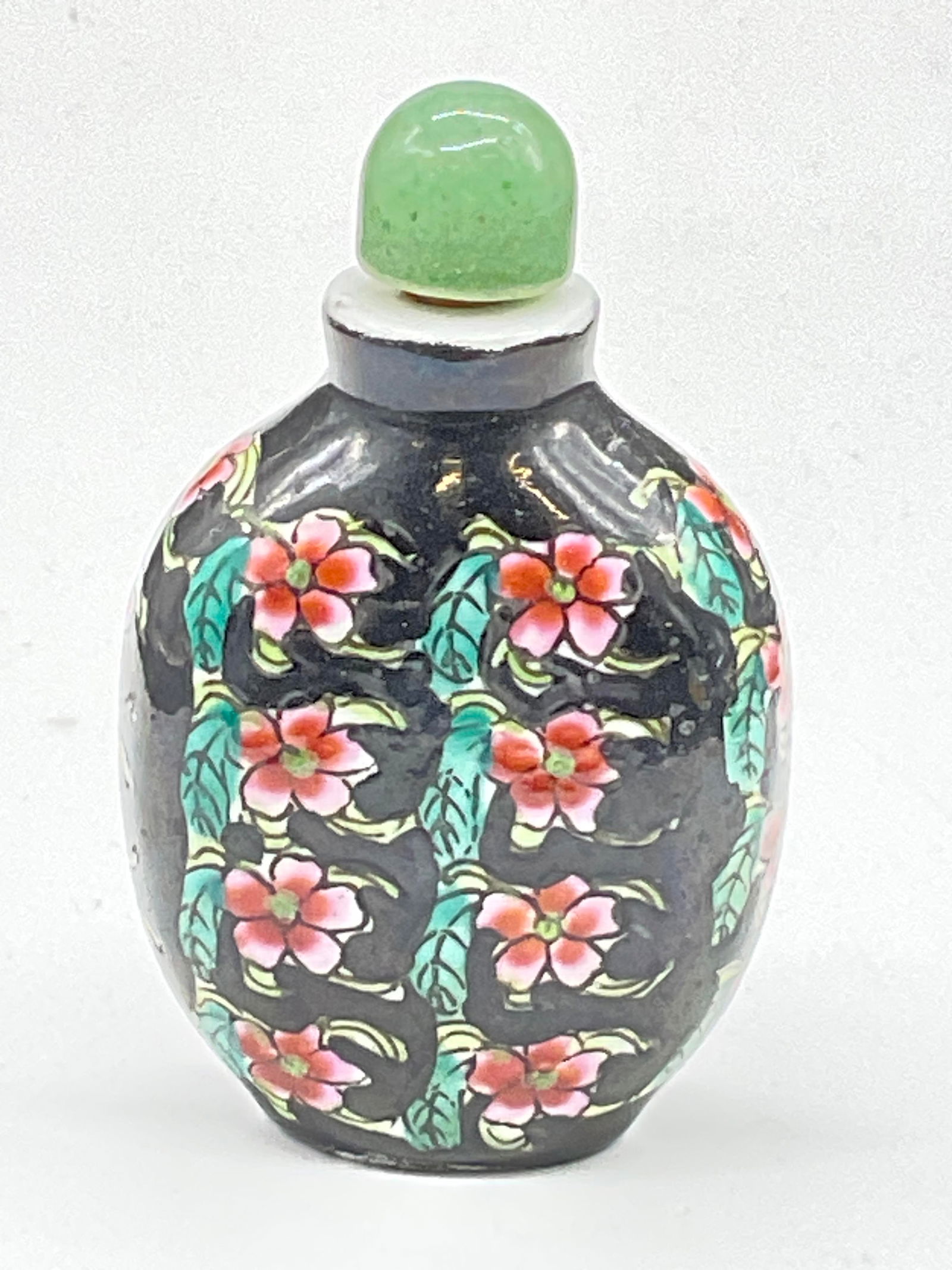 Vintage Hand Paint Asian Ceramic Snuff Bottle, Lid: Vintage Hand Painted Asian Ceramic Snuff Bottle with Polished Natural Green Stone Lid. Affixed to the lid is a piece of cork and a bone, possibly faux bone, snuff scoop. Hand painted floral motif to t