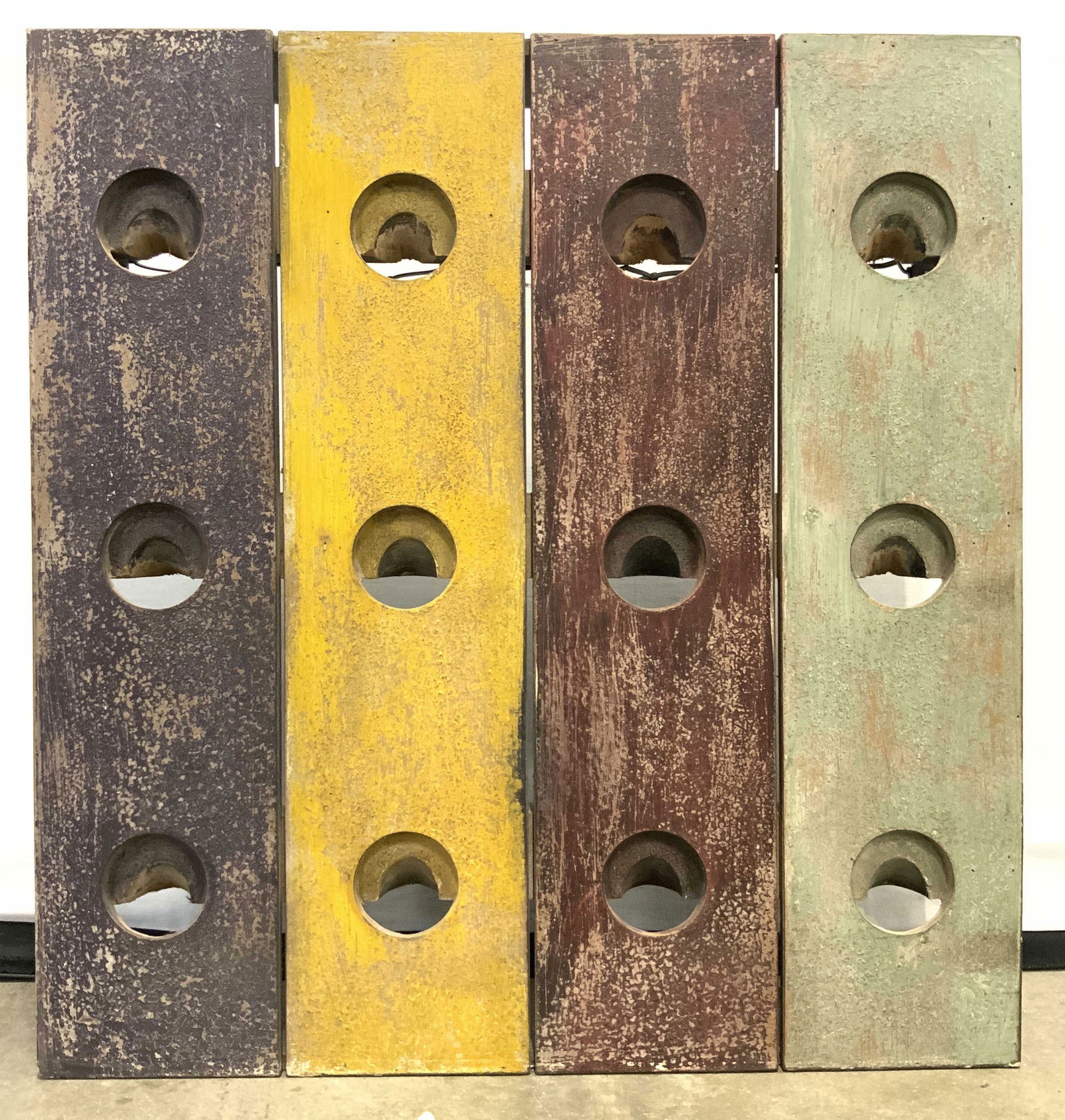 Vintage Wall Mount Wine Bottle Rack: Wine bottle rack appears to be wooden. Piece has purple, yellow, green, & red tones. Wall Mount wine bottle rack is vintage. Piece has 12 wine bottle spaces. Measures approximately 23.5 inches tall 22