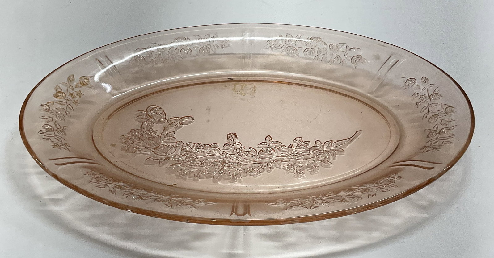 Vintage Pink Depression Glass Floral Platter: Vintage pink depression glass oval platter with floral design. Measures approx 12.25 x 9 inches. Some wear including scratching observed. Depression glass, depression glass platter, pink platter, flor