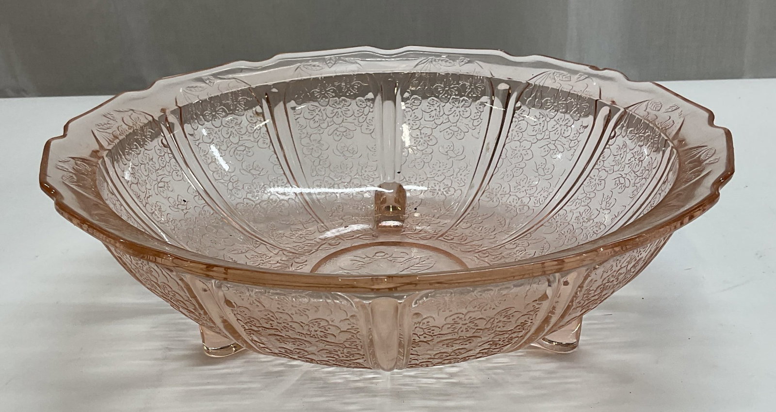 Vintage Pink Depression Glass Footed Bowl: Vintage pink depression glass footed bowl with floral design. Measures approx 10.25 x 3.25 inches. Some wear including scratching and small chip observed. Depression glass, depression glass bowl, pink