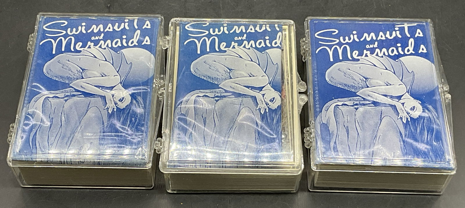 Group Lot SWIMSUITS & MERMAIDS Trading Cards 1995+: Group Lot SWIMSUITS & MERMAIDS Collectible Trading Cards. Not all of the pieces have been examined. Cards are contained in hard plastic cases. The cases measure approx. 3.75L x 2.75W in. Some original