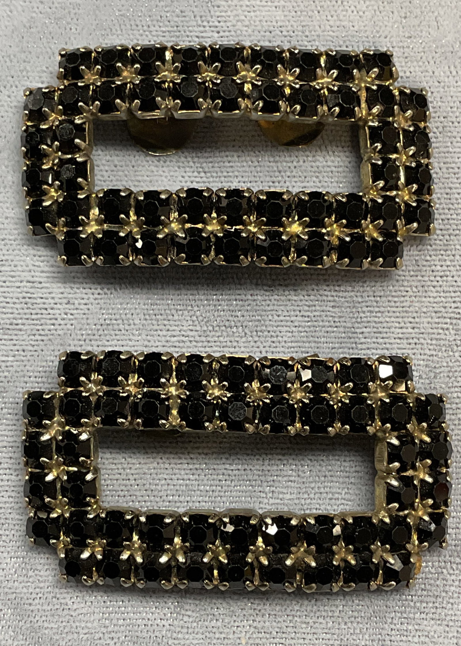 Pair Vintage Musi Black Crystal Shoe Clips: Pair of vintage Musi silver tone rectangular shaped black crystal shoe clips. Signed on clips. Measure approx 2 x 1 inches each. Some wear to each including scratching observed. Jewelry, estate jewelr