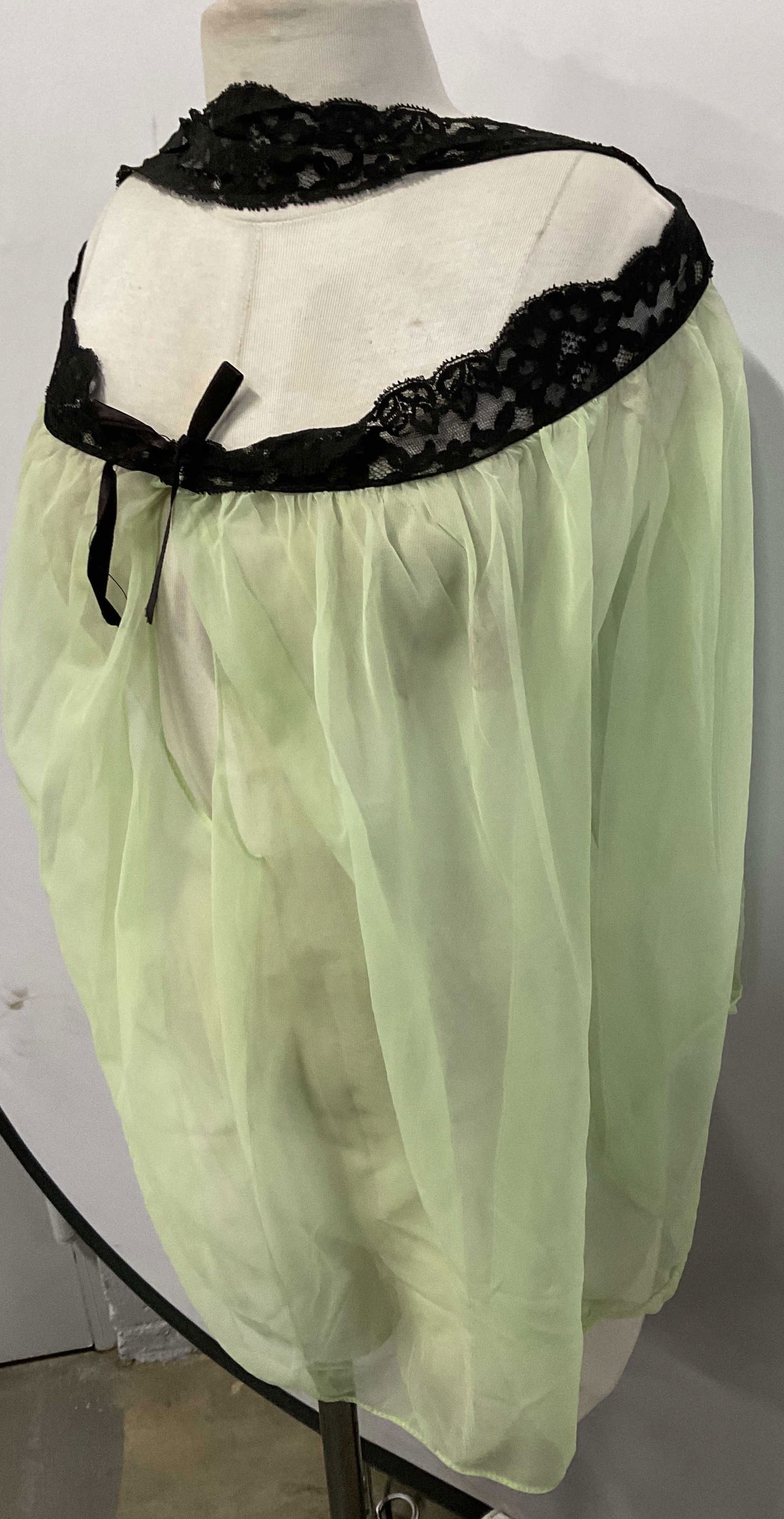 HOUSE OF VALENTINE Vntg Sheer Green Nightie: Vintage HOUSE OF VALENTINE Sheer Green Nightie. Black lace accent with open fabric center below lace. Tag reads HOUSE OF VALENTINE, 100% NYLON, S. Measures approx. 27 inches in length, measured flat.