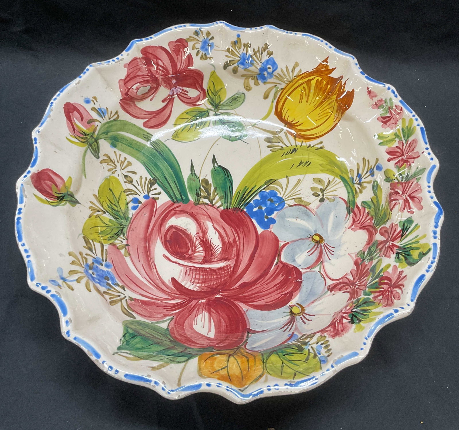 Vintage Hand Painted Floral Ceramic Bowl, Italy: Vintage hand painted ceramic bowl with floral motif. Scalloped rim. Marked Italy on underside. Measures approx. 13 x 3.5 inches. Some surface wear including scratching and some loss to glaze observed.