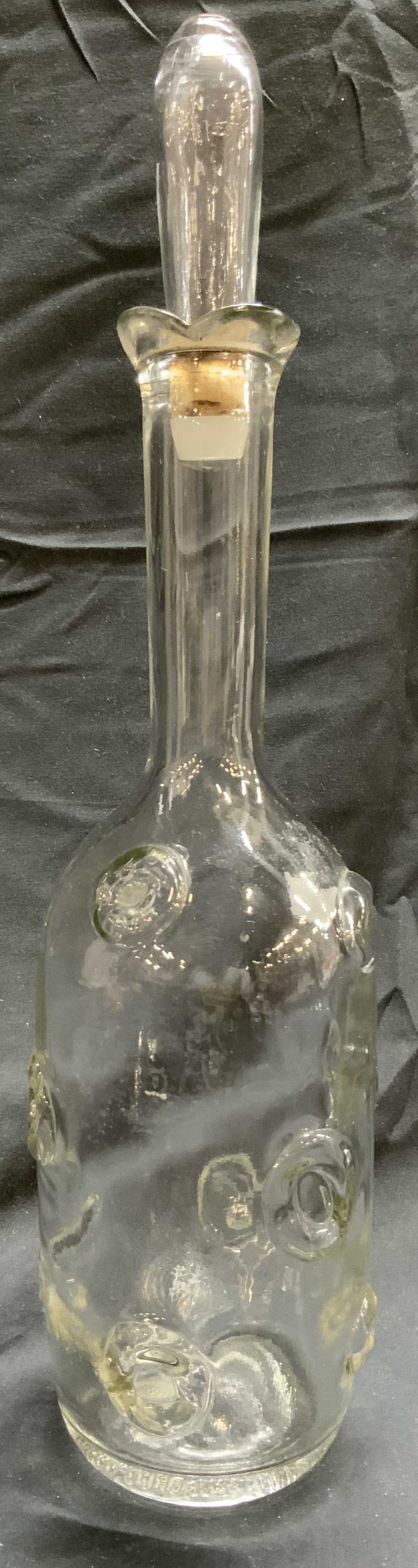 Vintage Art Glass Liquor Decanter W Stopper: Decanter is Vintage. Piece is glass. Decanter includes stopper. Piece has circular form beveled relief detail. Decanter measures approximately 14 inches tall 3.5 inches wide. Decanter, vessel, vintage
