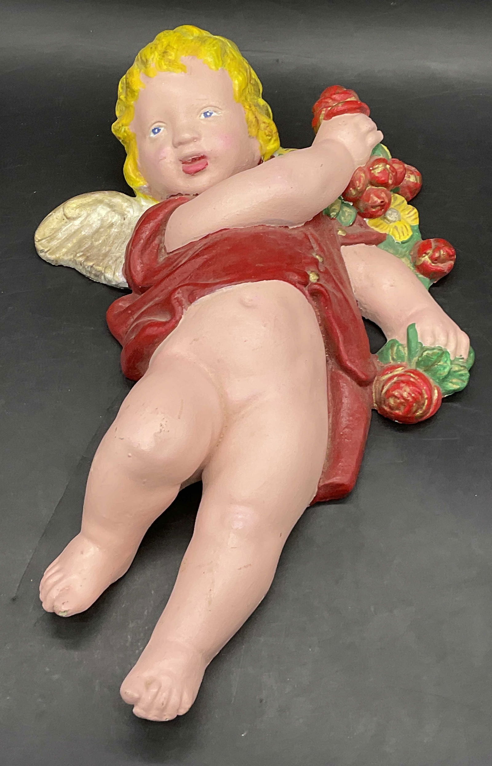 Hand Painted Cherub Figural: Hand Painted Cherub Figural. Appears to be crafted from a plaster material and a heavy finish. Measures approx. 12L x 7.5W in. Chipping, wear to paint, and surface wear present. home decor, home accen