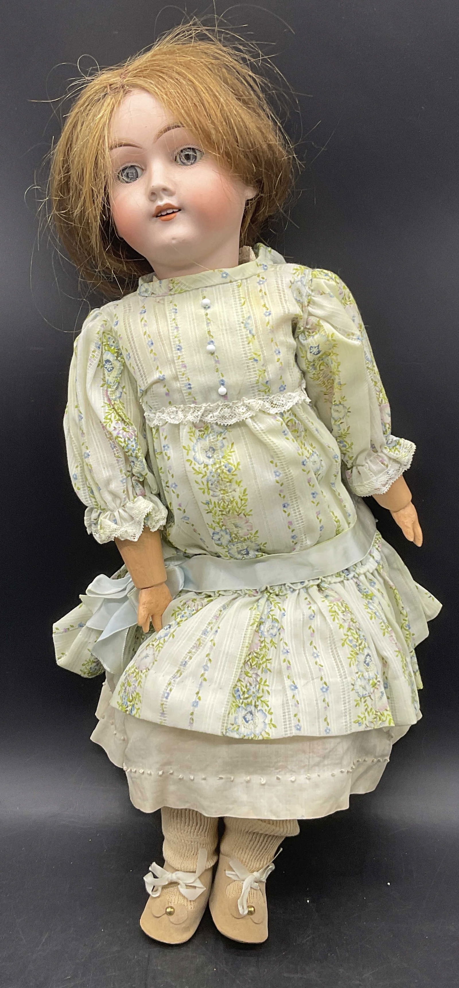Vintage Porcelain Head Female Doll, Germany: Vintage Porcelain Head Female Doll With Fabric Dress. Arms appear to be crafted from wood and painted. Legs appear to be crafted from papier-mache and finished with a heavy coating. Measures approx. 2