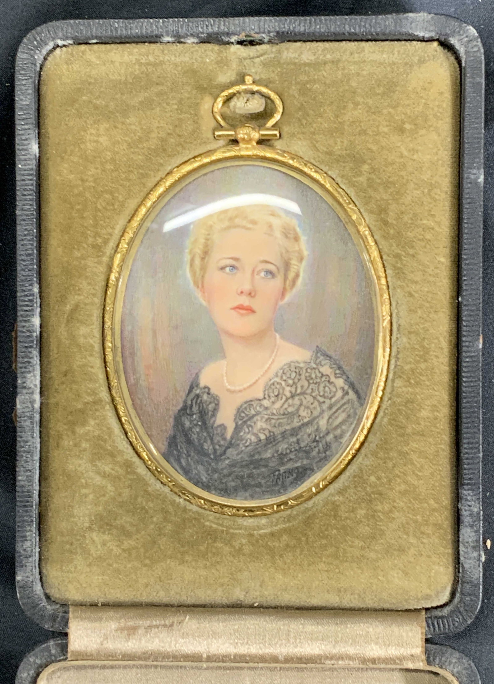 Vintage Miniature Hand Painted Portrait of a Woman: Miniature vintage hand painted portrait. Signed in lower right corner Patino. Subject depicts a woman with blonde hair and a pearl necklace in lace. Framed in a gold toned metal frame with a metal han
