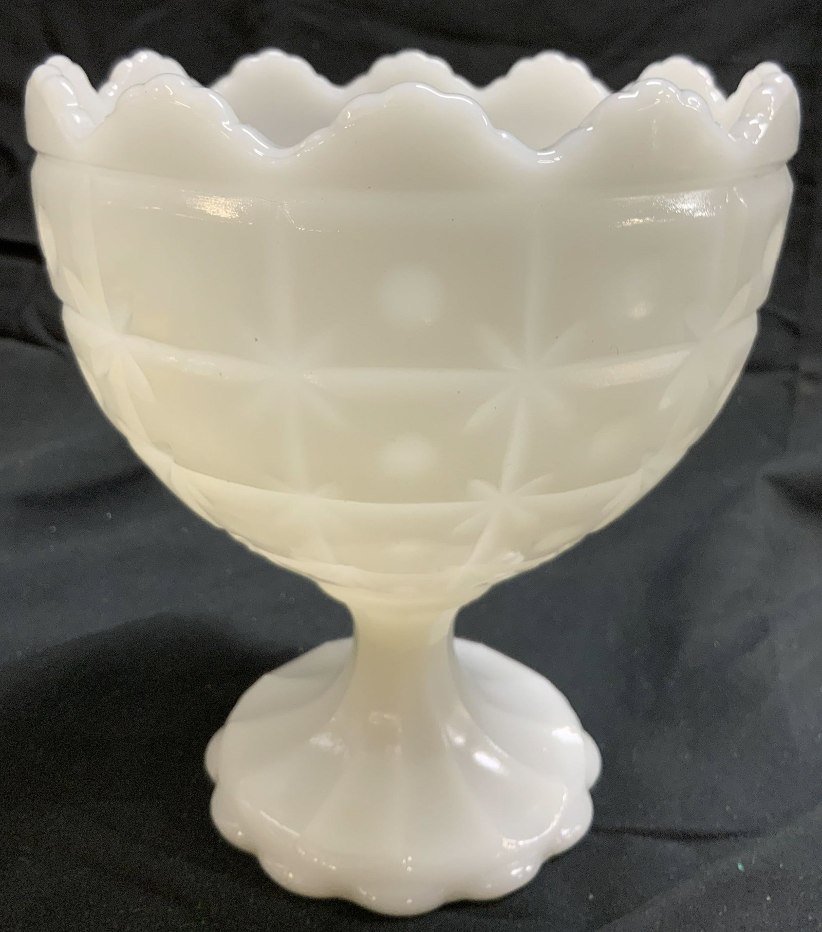 NAPCO Milk Glass Goblet W Relief Detail: Underside reads NAPCO CLEVELAND O USA. Milk glass goblet. Piece is white toned & opaque. Piece has geometric relief detail to exterior. Vessel has tooth rim. Piece measures approximately 6.5 inches ta