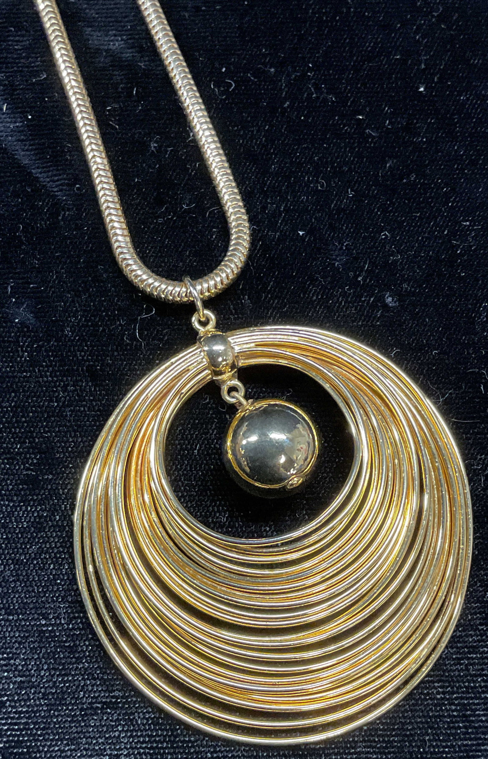 Vintage Gold Tone Circle Pendant Necklace: Vintage gold tone snake chain necklace with round wire and round bead pendant. Drop length approx 12 inches. Pendant approx 2.25 inches long. Some wear including scratching. Jewelry, estate jewelry, c