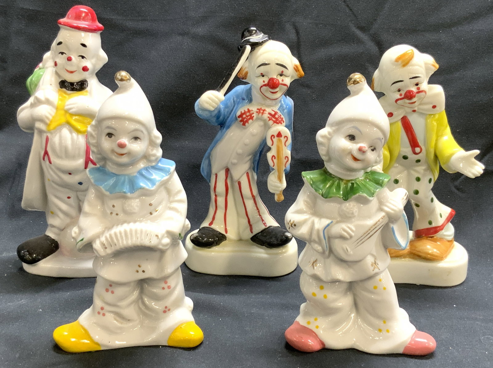 HOMCO Lot 5 Porcelain Clown Figures: Lot includes 5 clown figures. Tags on Undersides of 2 read HOMCO. Each clown figure is hand painted and porcelain. Largest clown figure measures approximately 6.5 inches tall 3.5 inches wide 2.5 inche