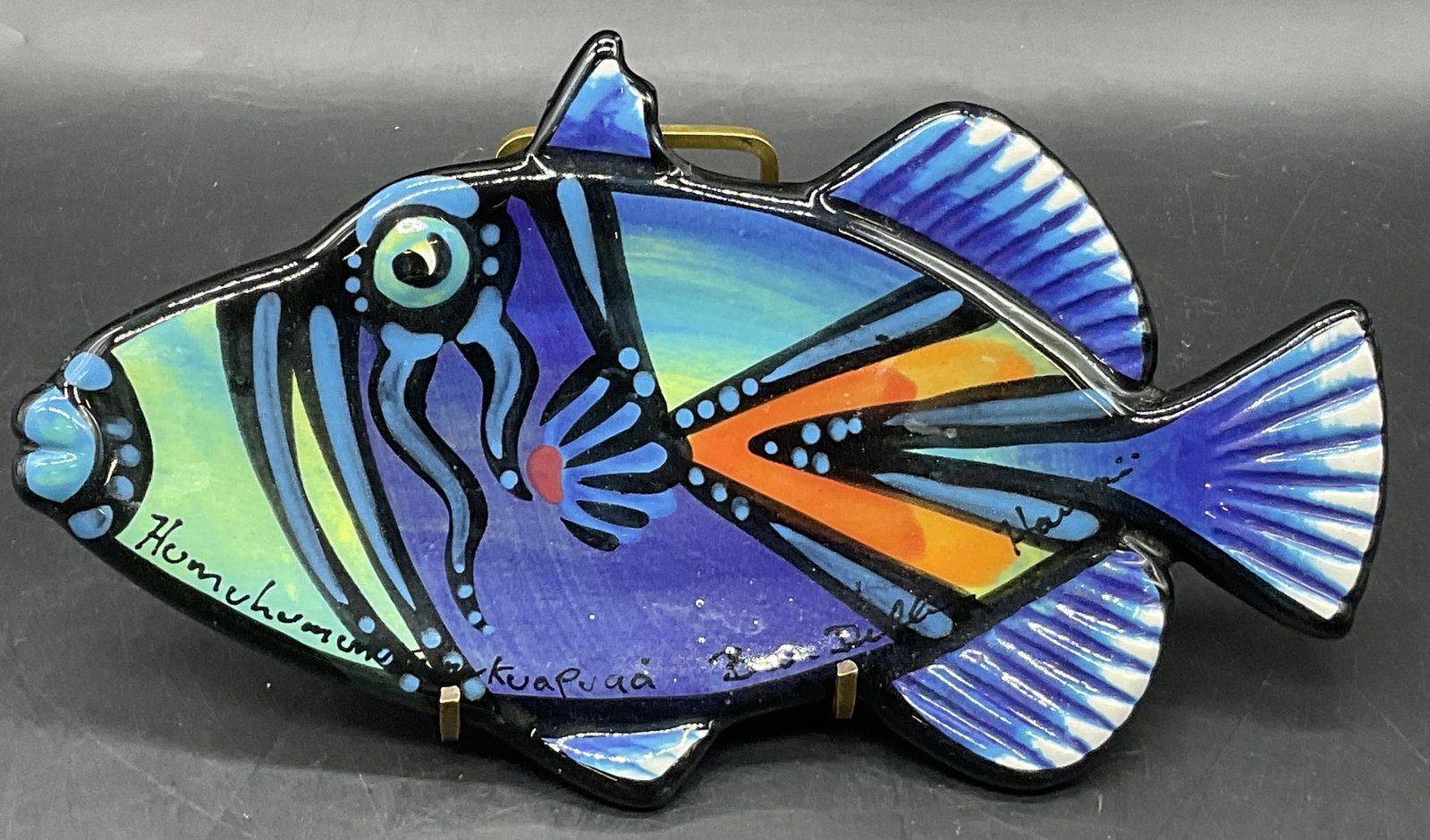 BENJAMIN DILLER HAWAIIAN REEF FISH PLATE, Hawaii: BENJAMIN DILLER HAWAIIAN REEF FISH PLATE. Crafted from ceramic. Multicolored hues throughout. Measures approx. 9.5W x 5.25L in. Underside sticker reads CERTIFICATE OF AUTHENTICITY ORIGINAL HAWAIIAN RE