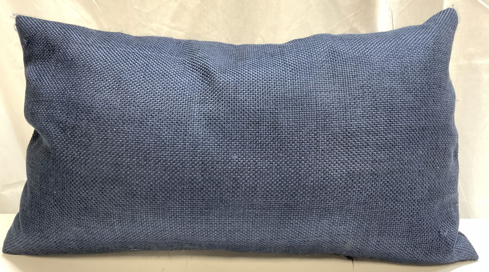 Woven Texture Navy Lumbar Throw Pillow: Pillow is navy blue toned. Piece has woven texture. Lumbar throw pillow. Pillow measures approximately 25 inches long 14 inches tall. Pillow, lumbar pillow, throw pillow, navy pillow, homewares, home