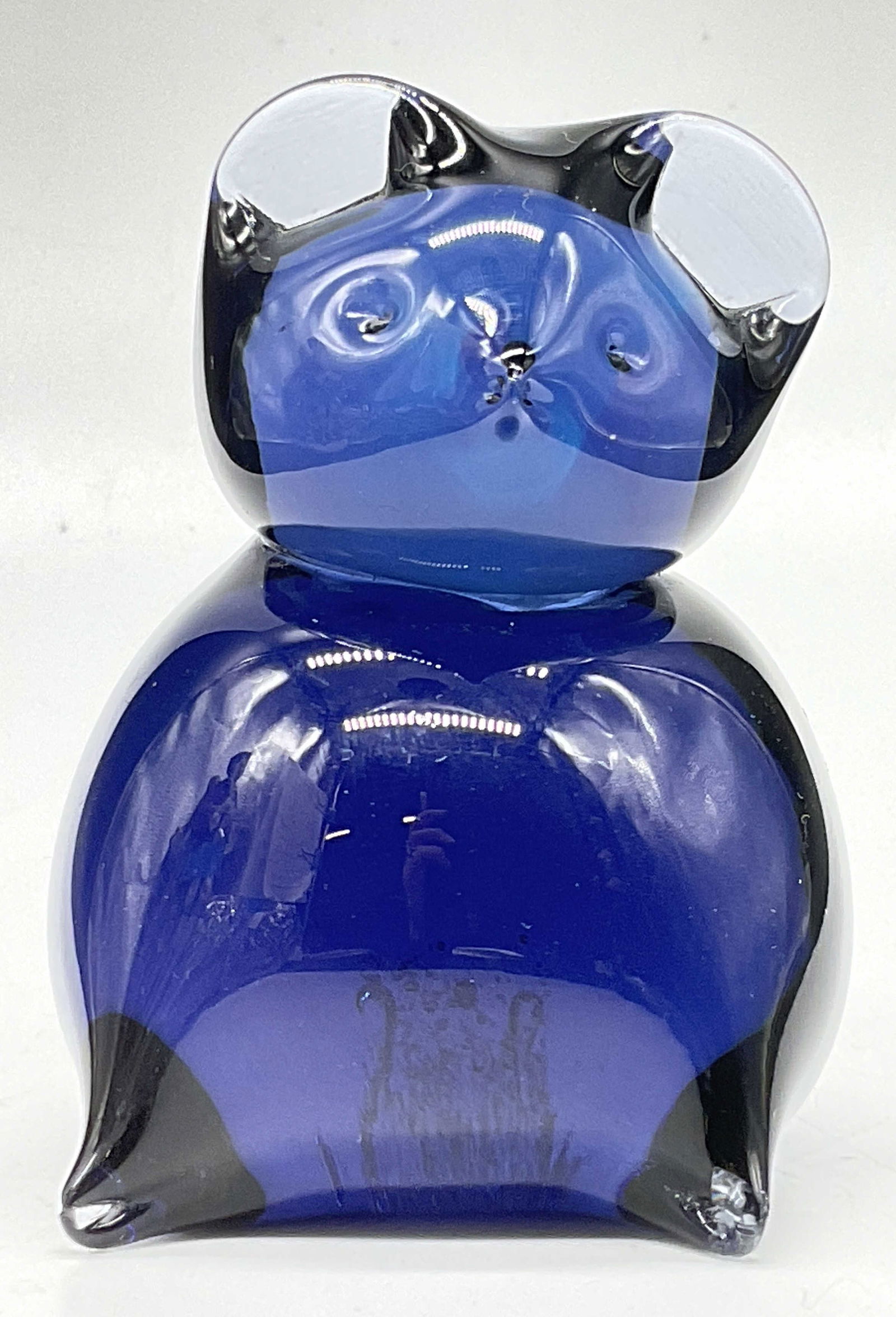 Art Glass Animal Figural Paperweight: Art Glass Animal Figural Paperweight. Deep purple-blue hue. Pontil to the underside. Possibly a mouse, bear, or another similar looking animal with rounded ears. Measures approx. 3H x 2W in. Pontil to