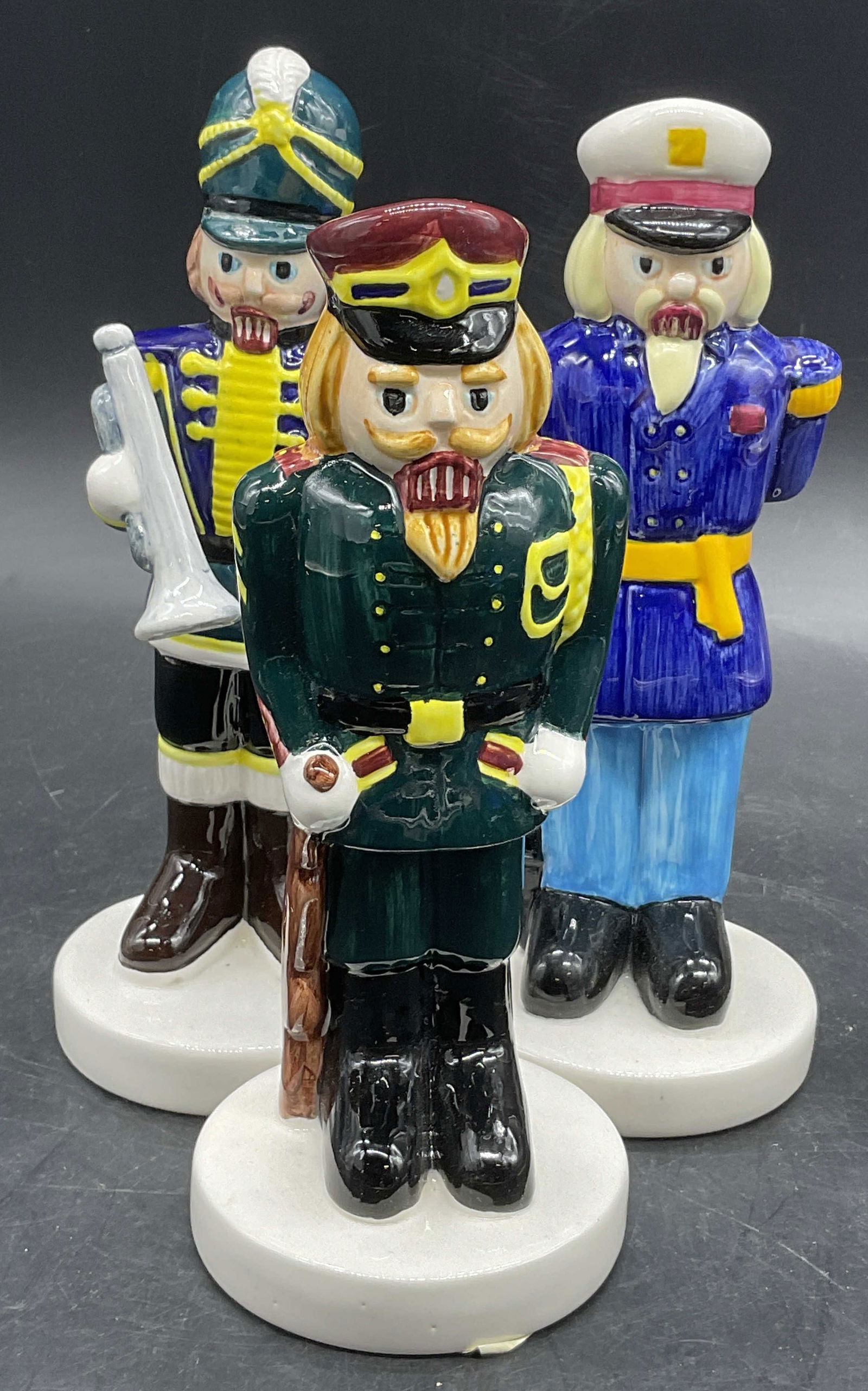 SCI SUPERGIFT CONCEPT INC Painted Ceramic Figurals: SCI SUPERGIFT CONCEPT INC Hand Painted Ceramic Figurals. Subjects are soldiers holding weapons or musical instruments. Similar in size. Tallest measures approx. 7H x 2.75W in. Stickers to undersides r