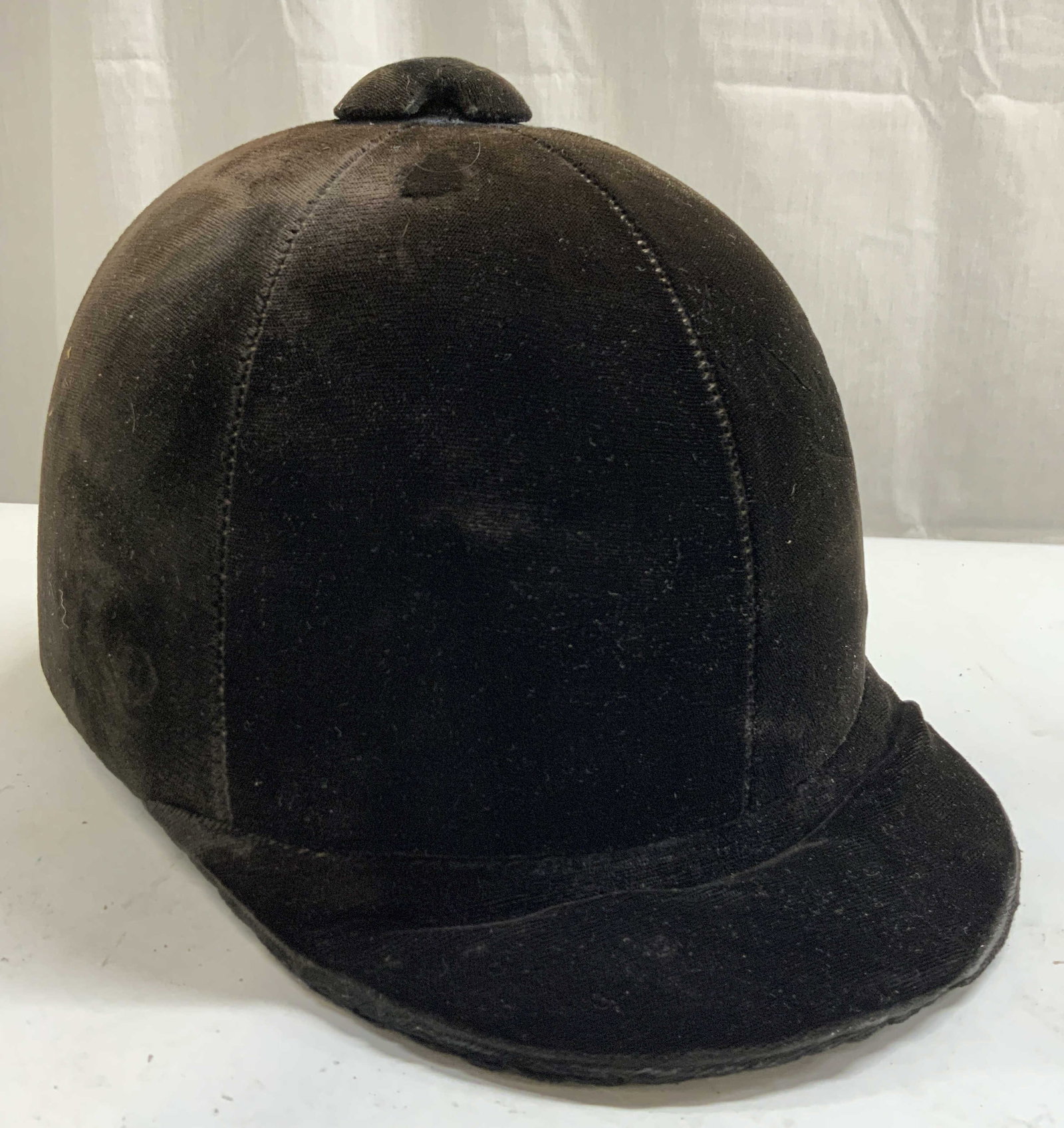 Velvet Equestrian Horse Riding Helmet: Tag on interior reads Crafted With Pride In USA. Helmet has crushed velvet exterior. Riding helmet has short brim to front. Piece is dark chocolate toned. Size unmarked. Piece measures approximately 1
