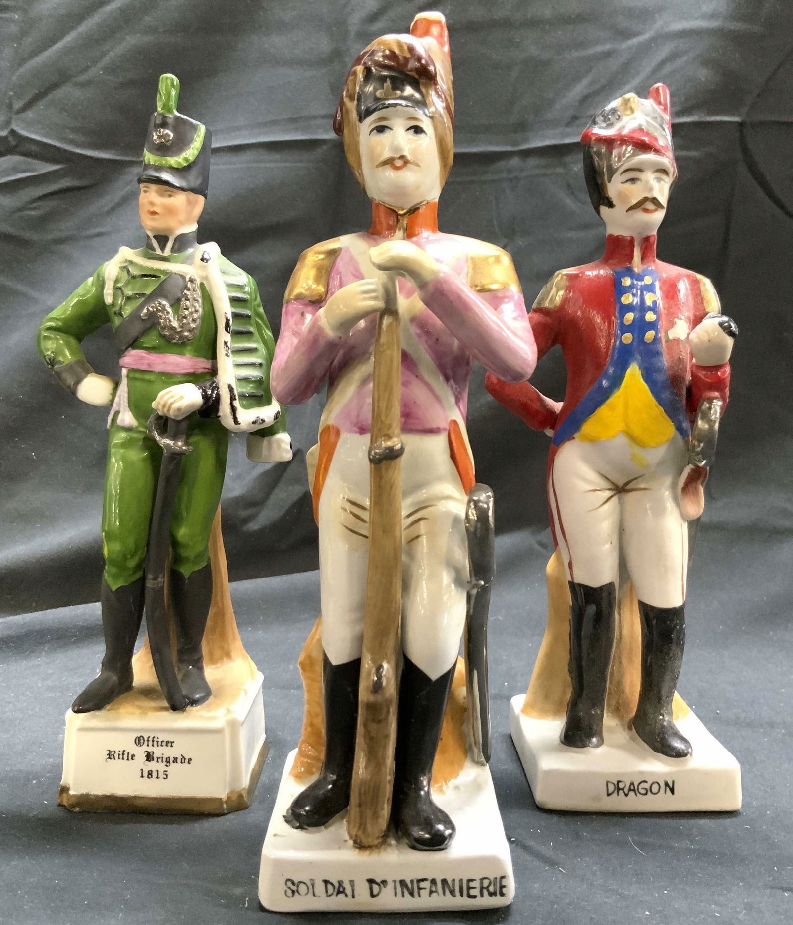 CAPODIMONTE Lot 3 H Painted Porc Soldiers: Lot includes 3 porcelain soldier figures. Each piece appears to be CAPODIMONTE (no apparent markings). Lot includes DRAGON, SOLDAL D INFANIERIE, & Officer Rifle Brigade 1815. Figures appear to have ha