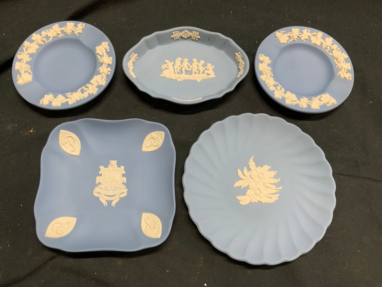 WEDGWOOD Lot 5 Asst Trinket Dishes ENGLAND: Undersides are inscribed WEDGWOOD MADE IN ENGLAND. Lot includes 5 trinket dishes. Each are light blue with raised white toned detail. Largest piece in lot measures approximately 5 inches wide. Wedgwoo