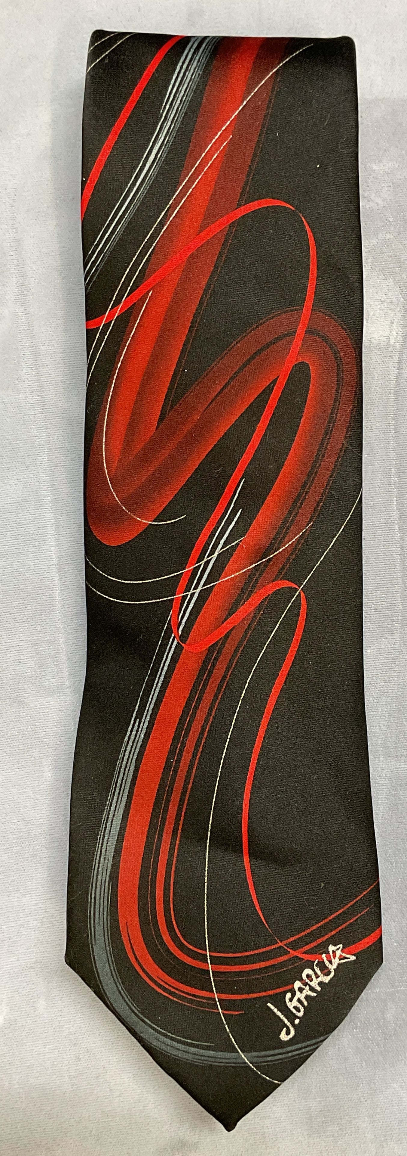 Jerry Garcia Capillaries Collectors Edt Black Tie: Jerry Garcia J Garcia Capillaries Collectors Edition black and red graphic print tie. Signed on label. Polyester. Measures approx 58 inches long. Some wear to material consistent with exposure. Tie, m