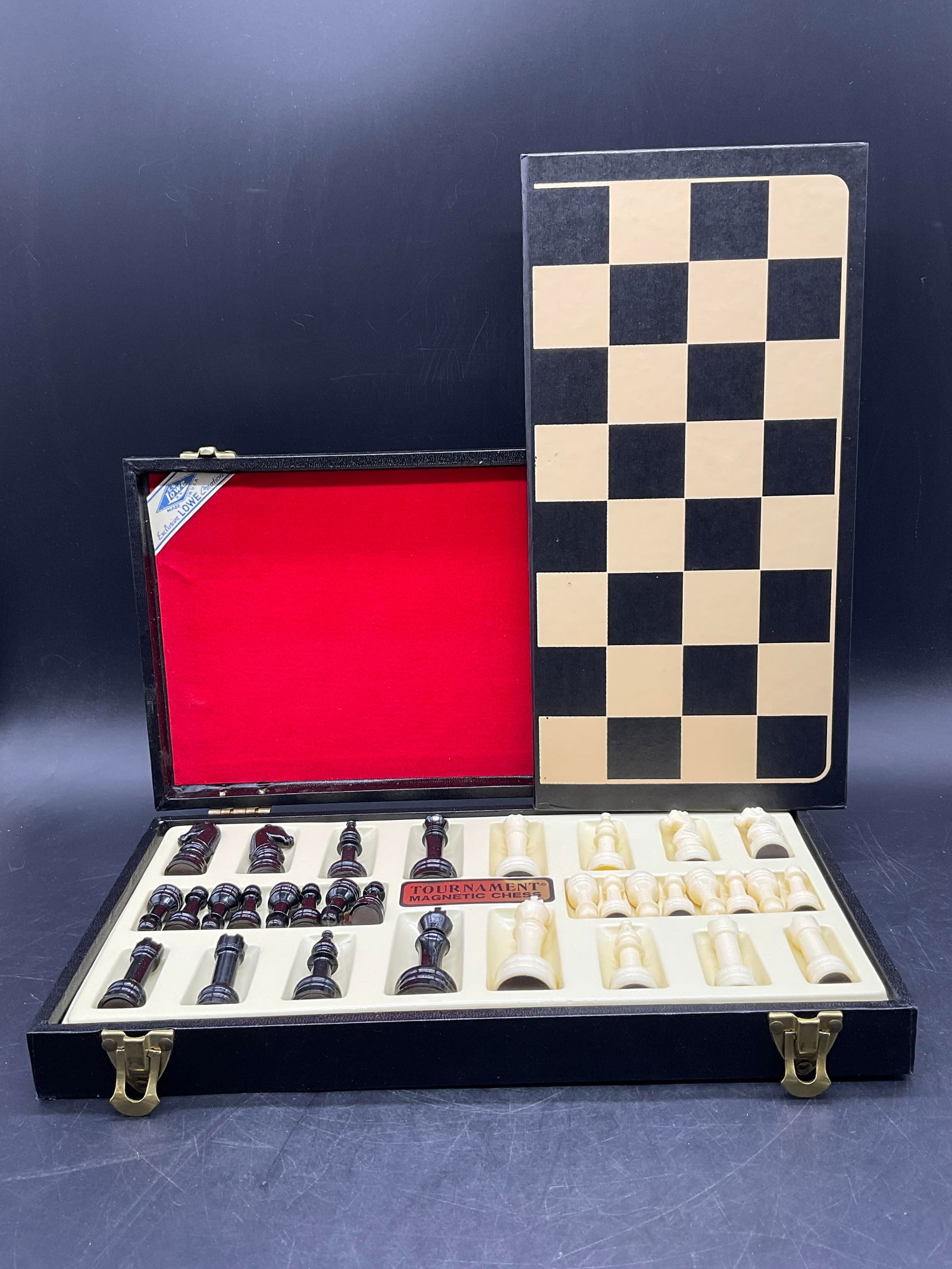 LOWE CREATIONS USA Tournament Magnetic Chess: LOWE CREATIONS USA Tournament Magnetic Chess. Comes with a game board. Pieces come in a black carry case. Pieces are crafted from composite / plastic materials. Case reads LOWE CREATIONS USA. The case