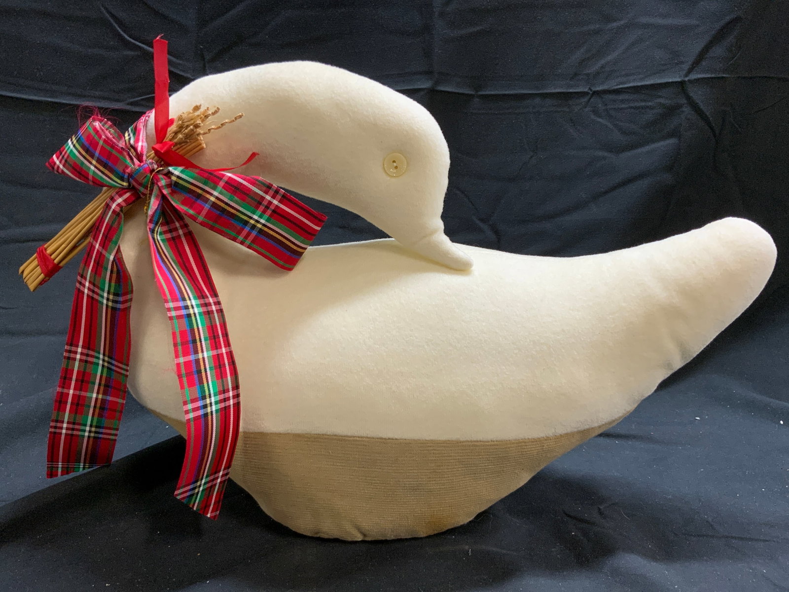 Vintage Stuffed Holiday Duck Figure: Duck figure is vintage. Piece is crafted from cloth & is stuffed. Duck figure has red, white, black, green & yellow toned plaid ribbon tied into bow around neck. Piece is cream and tan toned. Duck mea