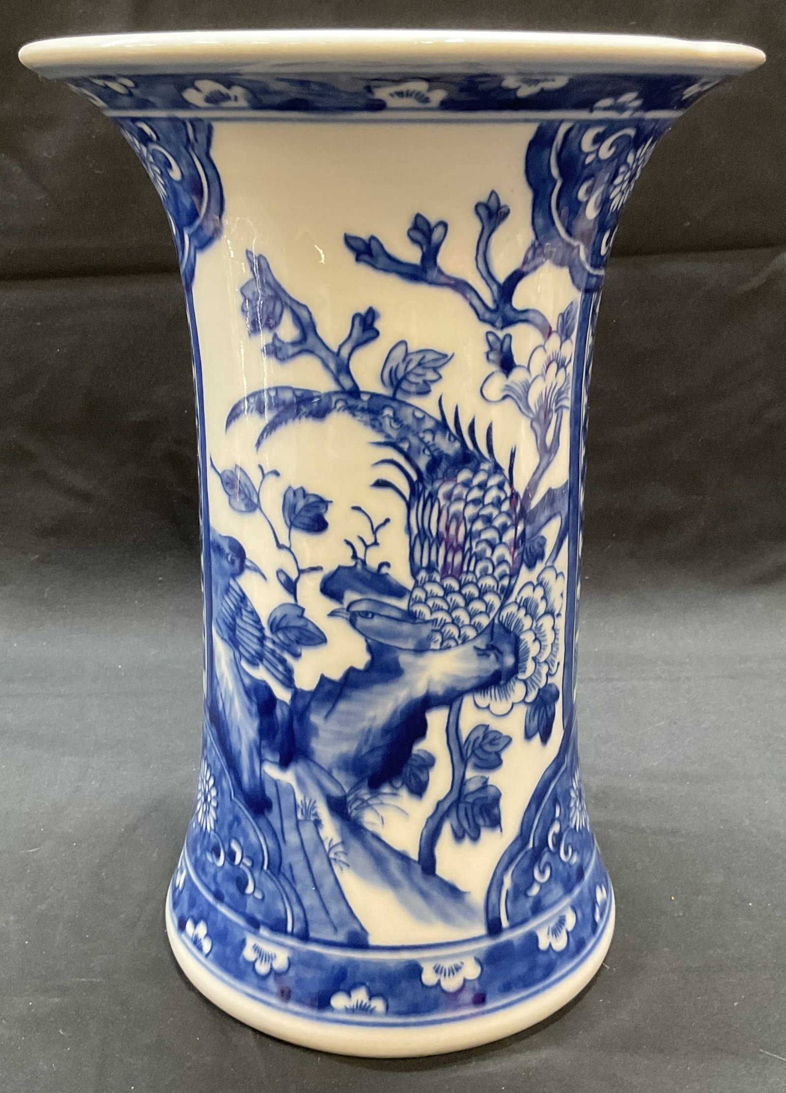 Blue & White Pheasant Porcelain Vase: Blue and white porcelain vase with pheasant panel design. Fluted rim. Measures approx. 7.5 x 10.5 inches. Piece has weight. Some surface wear including scratching observed. Blue and white vase, pheasa