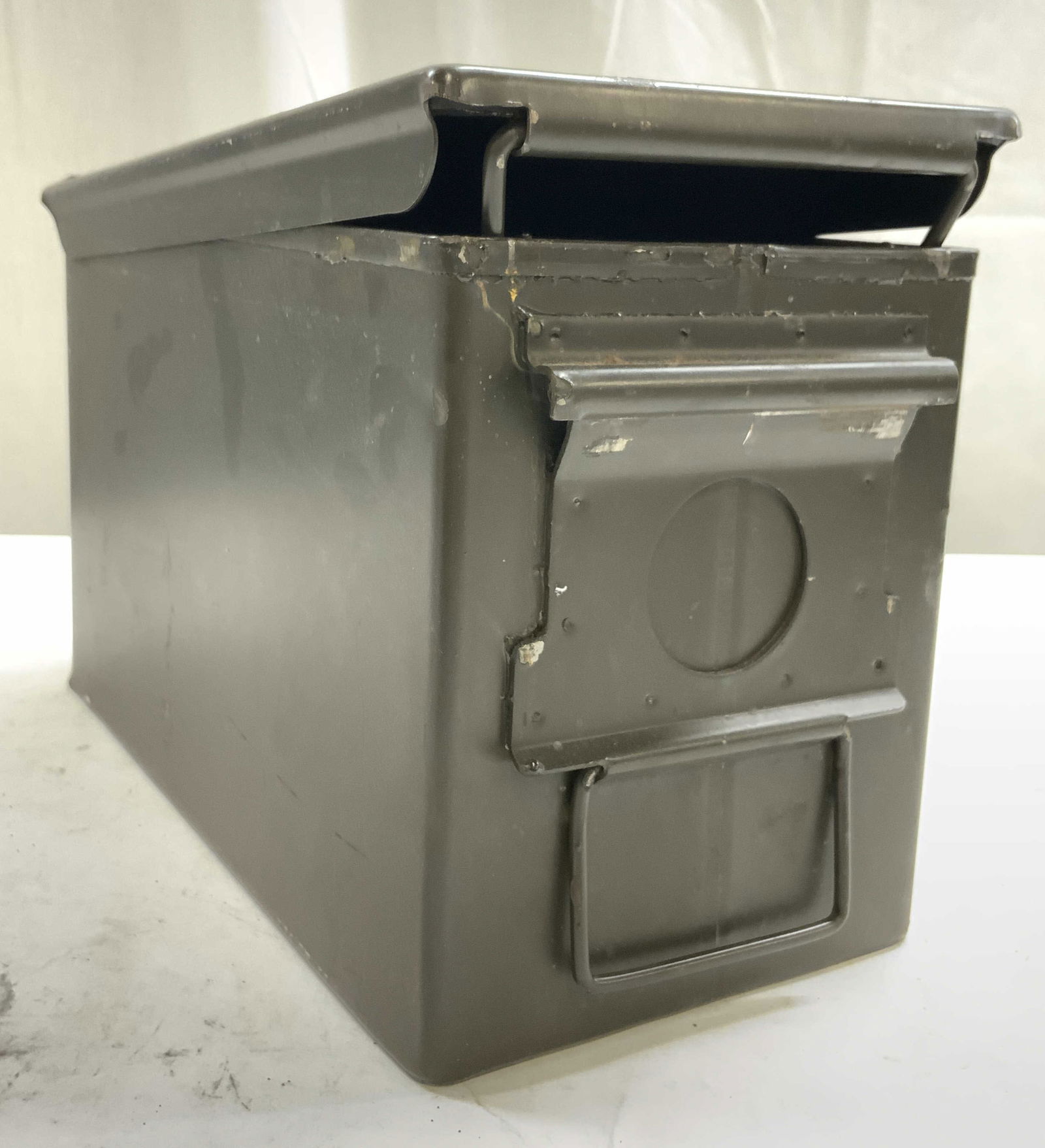 Vintage Metal Ammo Storage Box W Lid: Ammo storage Box is vintage & Metal. Piece is dark forest green toned. Box has hinged lid. Center of lid has handle. Piece measures approximately 12 inches long 7 inches tall 6 inches wide. Ammo stora