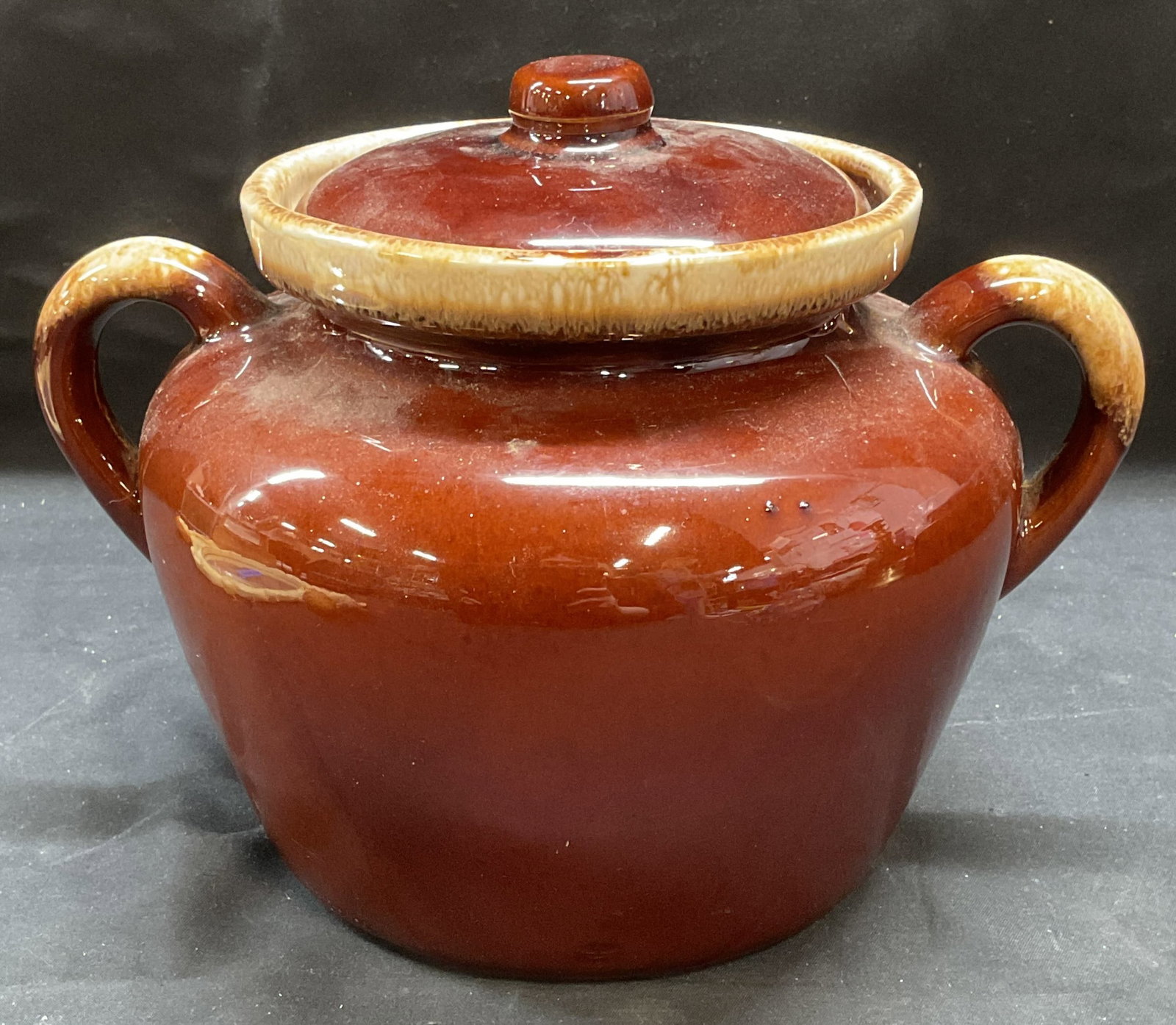 Vintage McCoy Pottery Brown Lidded Jar USA: Vintage McCoy pottery lidded jar in brown. Ovenproof. Signed on underside. Made in USA. Measures approx 9.5 x 7 x 6.5 inches. Some scratching and crazing observed. McCoy pottery, McCoy jar, lidded jar