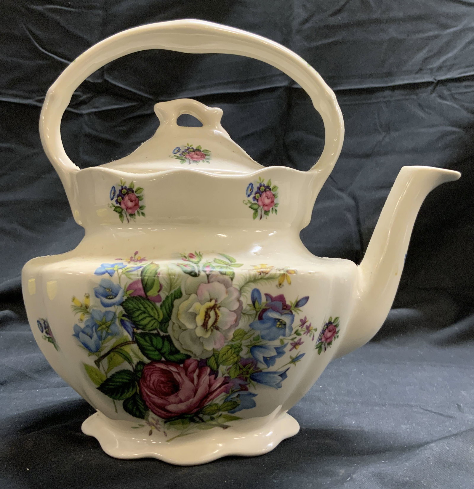 CROWNFORD BY GIFTWARE Porc Teapot W Lid: Underside is marked CROWNFORD BY GIRTWARE MADE IN ENGLAND. Teapot is cream toned and porcelain with intricate multi toned floral and leaf detail. Teapot includes lid. Piece measures approximately 8 in