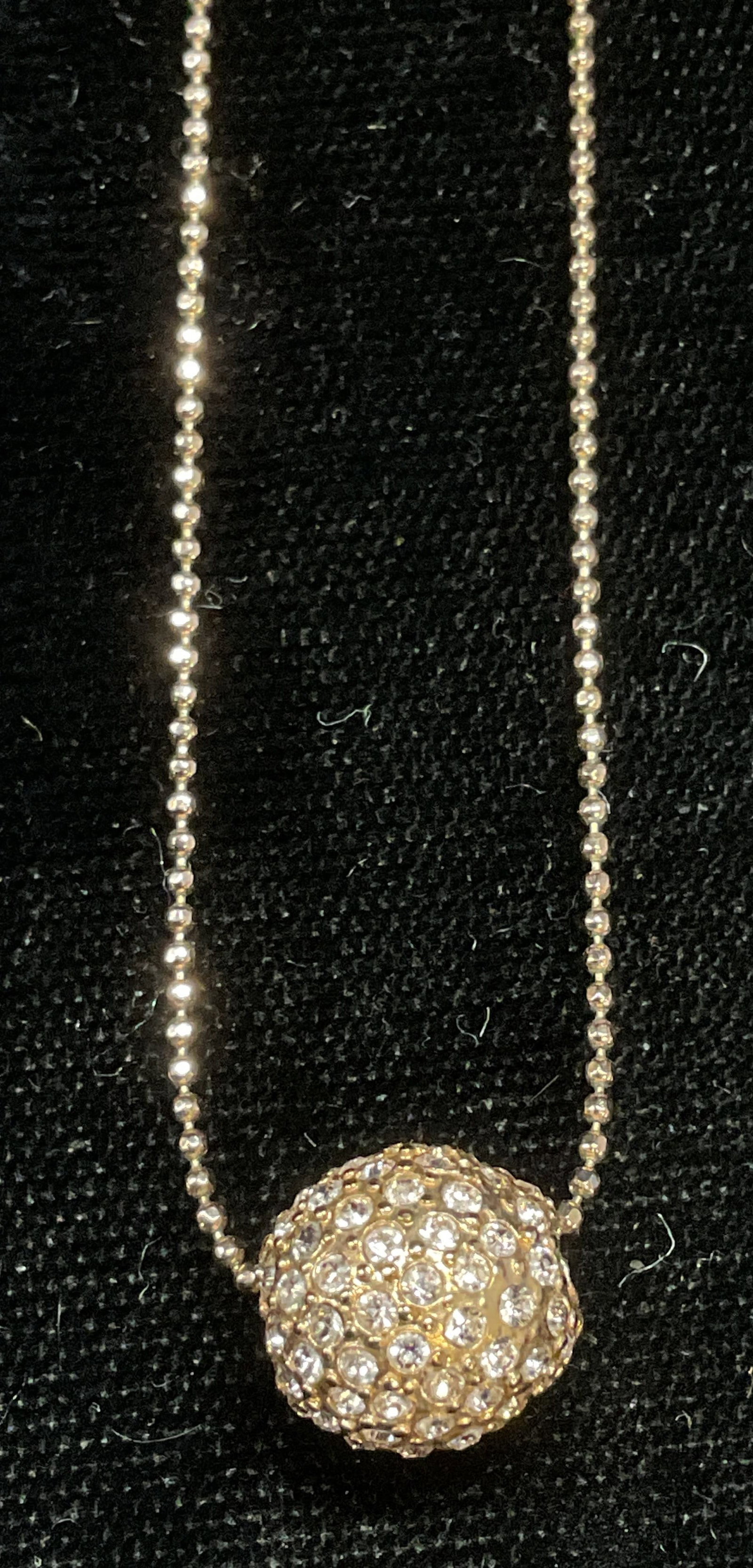 Swarovski Touchstone Gold Tn Crystal Necklace: Touchstone by Swarovski pendant necklace. Gold tone with Swarovski crystal decorated round pendant. Signed on hang tag. Includes box. Necklace drop length approx 8.5 inches. Some wear including scratc