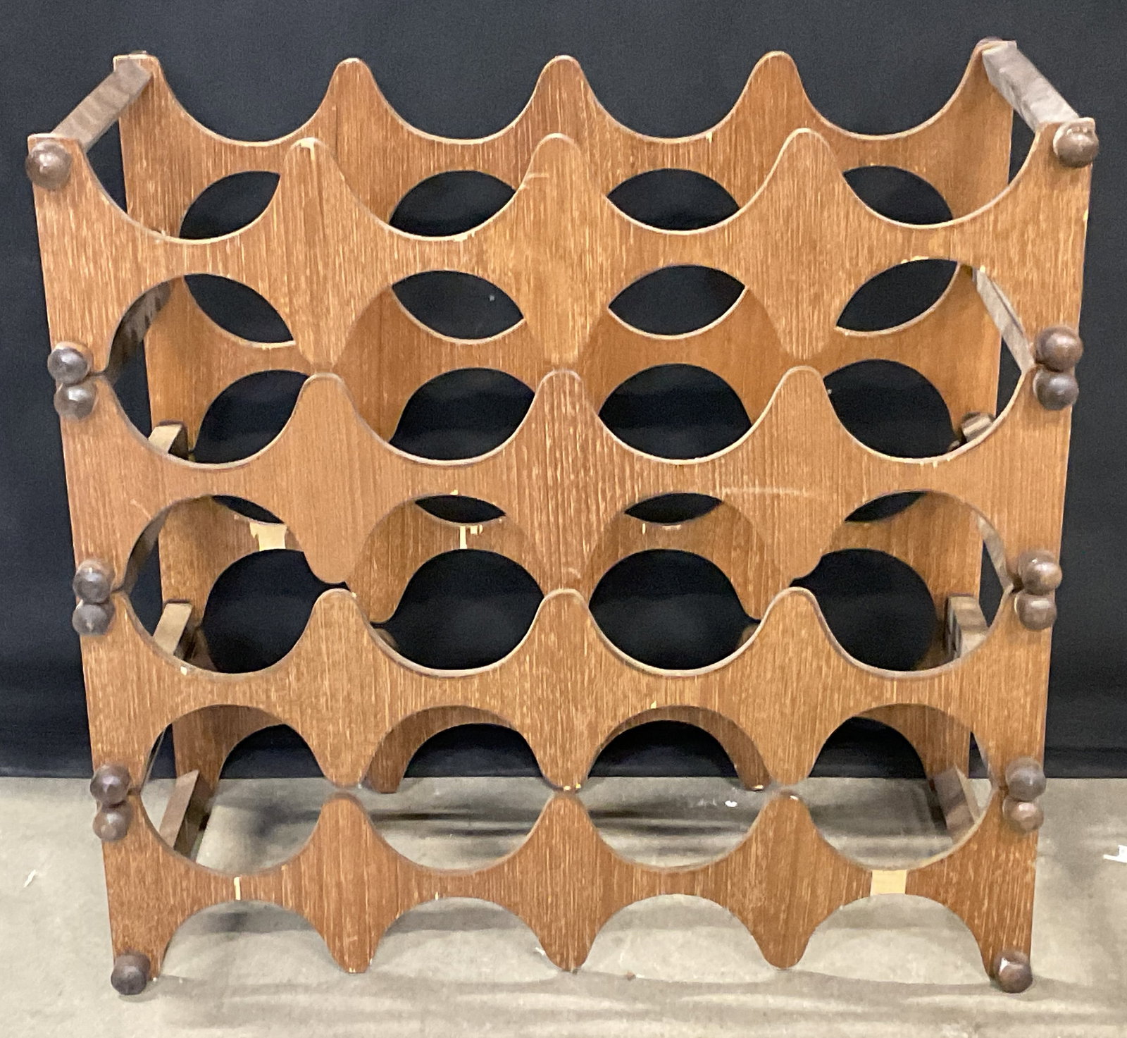 Mid Century Modern Wooden Wine Rack: A vintage mid century modern wooden wine rack. Measures approx. 17.5W x 16.5H x 7.5D in. Losses to wood. Surface wear present. The pieces appear to be adjustable. home decor, home accents, homewares, 