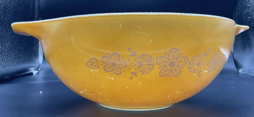 Vintage Pyrex Orange Toned Bowl with Flowers: Double handle Pyrex bowl, orange color with white flowers and wigs on side, underside reads Pyrex by Corning, Corning New York, baking and microwave 39, measures approx 13.5 inches by ht 4.5 inches wi