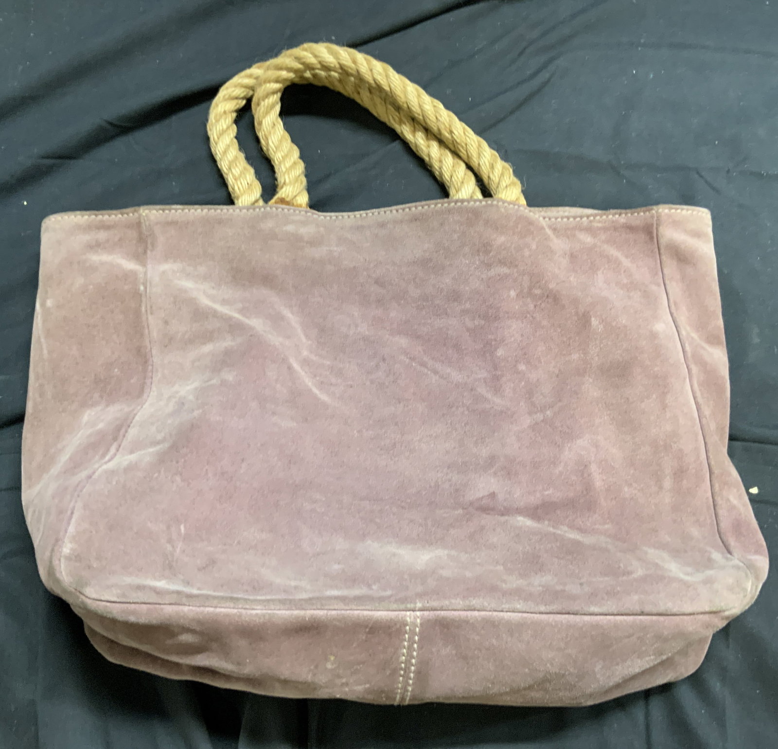 BARNEY NEW YORK Mauve Suede Tote ITALY: Interior reads BARNEY NEW YORK MADE IN ITALY. Tote is mauve toned and suede. Piece has tan toned corded rope style handles. Interior has 1 snap button pocket. Tote measures approximately 16 inches tal