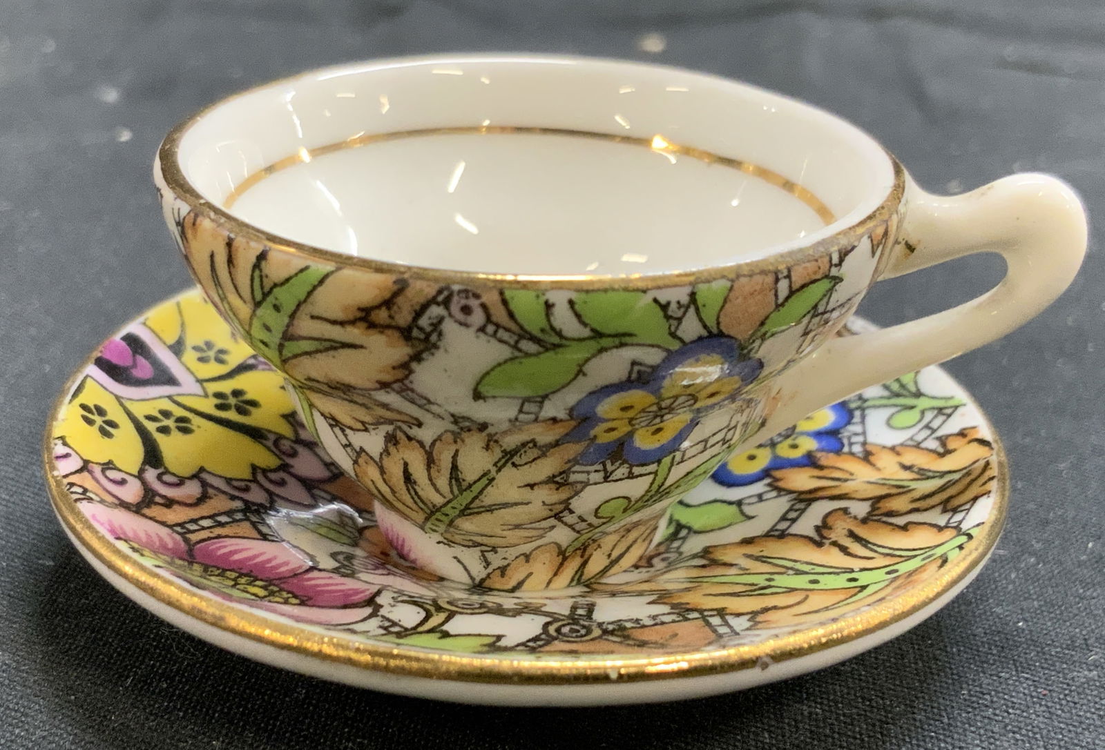 ROSINA BONE CHINA Mini Porc Teacup & Saucer: Underside is marked ROSINA BONE CHINA ENGLAND. Lot includes 1 miniature teapot, & 1 miniature saucer. Each piece has intricate multi toned floral and leaf detail. Saucer measures approximately 2 inche