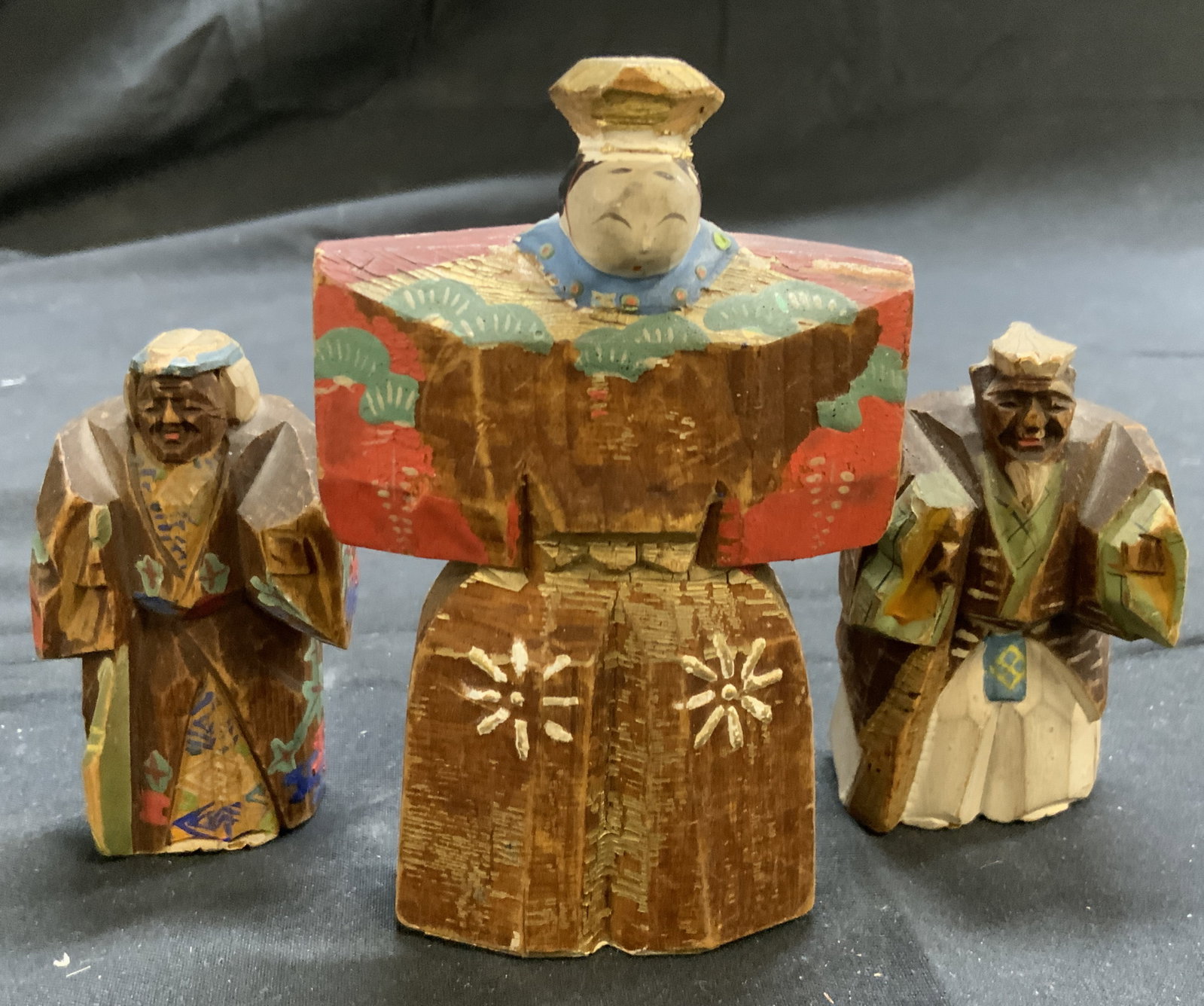 Asian Hand Painted Tachi Bina Dolls: Lot includes 3 carved wooden dolls. Each appears to be hand crafted. Largest piece measures approximately 3.5 inches tall 2.5 inches wide. Tachi bina doll, Asian dolls, Japanese dolls, Japanese Folk a