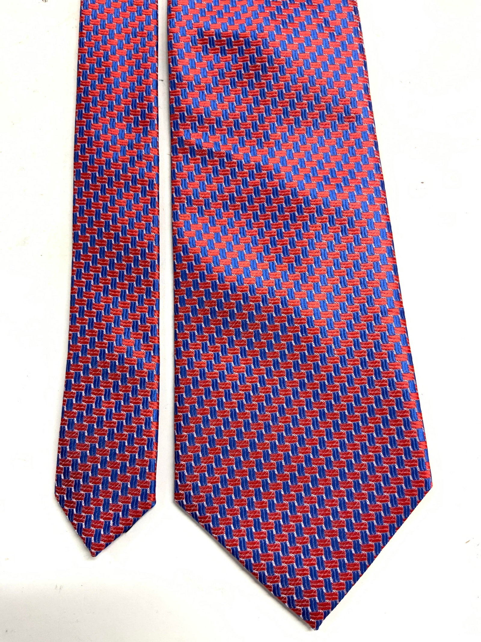 ALEX MISHRA Polyester Mens Necktie: Tag reads ALEX MISHRA. Necktie is polyester. Piece has red white and blue toned patterned detail. Neckties measures approximately 57 inches long 4 inches wide. Tie, Necktie, Alex MISHRA necktie, Mens 