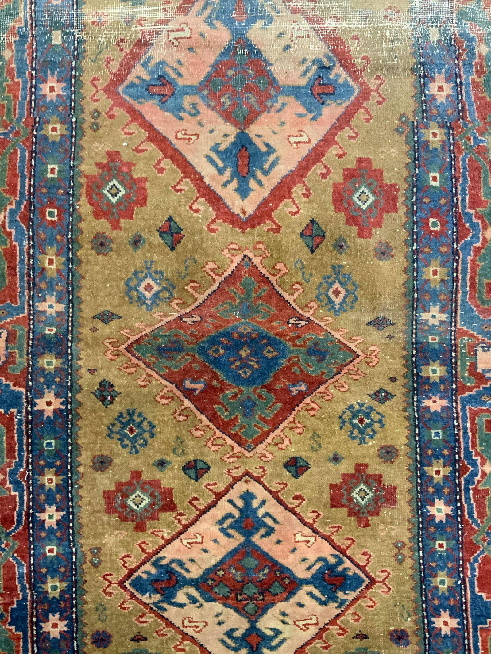 Vintage Handmade Turkish Wool Area Rug: Rug is handmade and wool. Piece is vintage, appears to be Turkish. Rug has intricate multi toned floral & geometric detail. Short cream toned edges. Measures approximately 65 inches long 38 inches wid