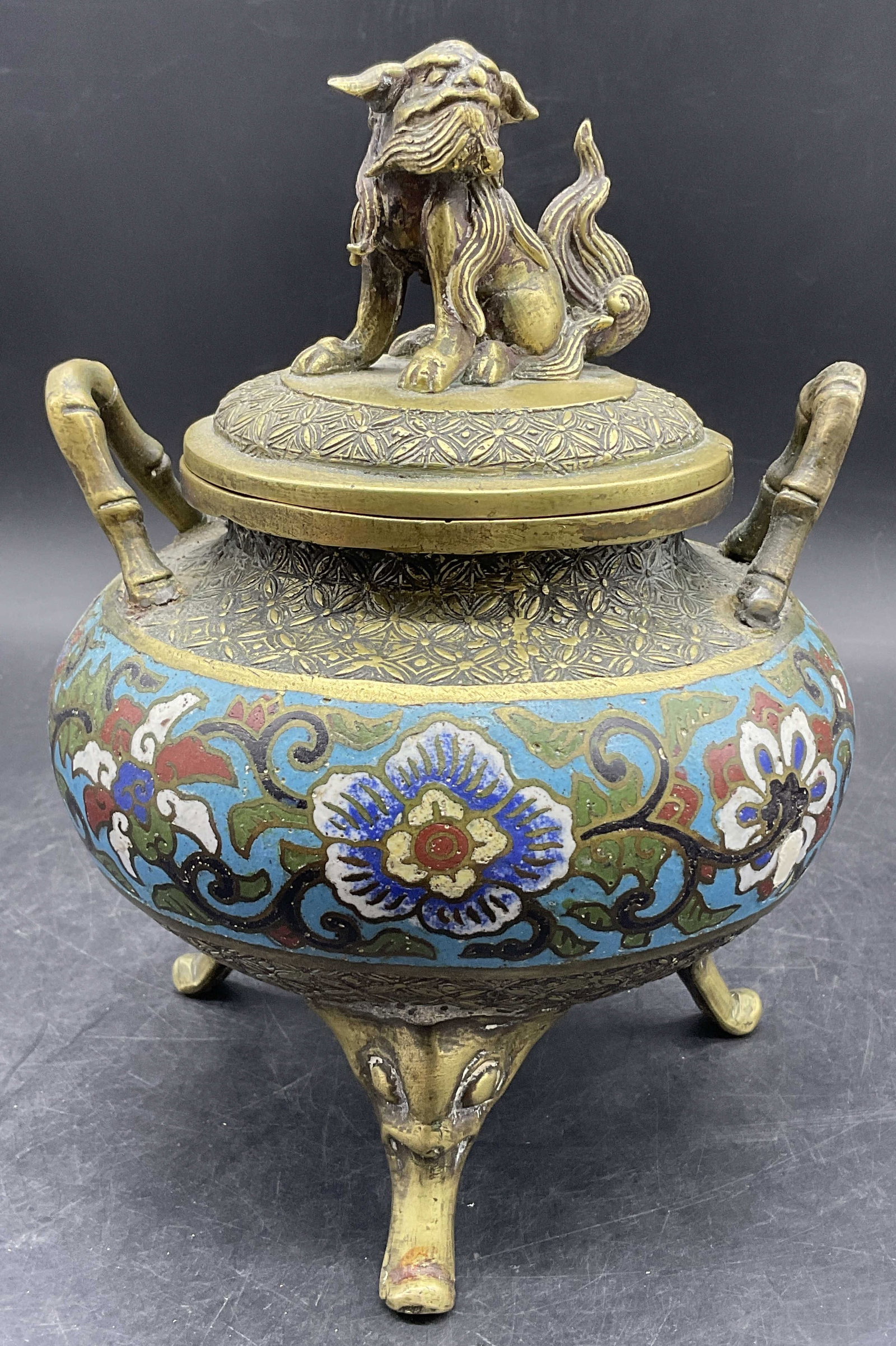 Vintage Asian Cloisonne Fu Dog Figural Incense Pot: Vintage Asian Cloisonne Fu Dog Figural Incense Pot / Incense Burner / Censer. Multicolored floral motif cloisonne to the piece. Gilt metal. Handles to either side. Tripod feet to the base. Lid feature