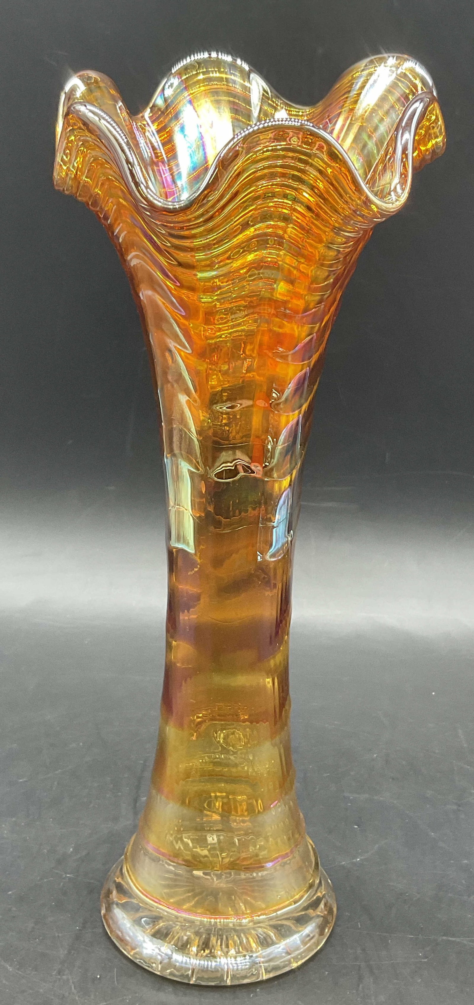Vntg Iridescent Orange Carnival Glass Swung Vase: Vintage Iridescent Orange Carnival Glass Swung Vase. Measure approx. 10.25H x 4W in. Surface wear consistent with age, use, and exposure. Indentation to the glass. home decor, home accents, homewares,