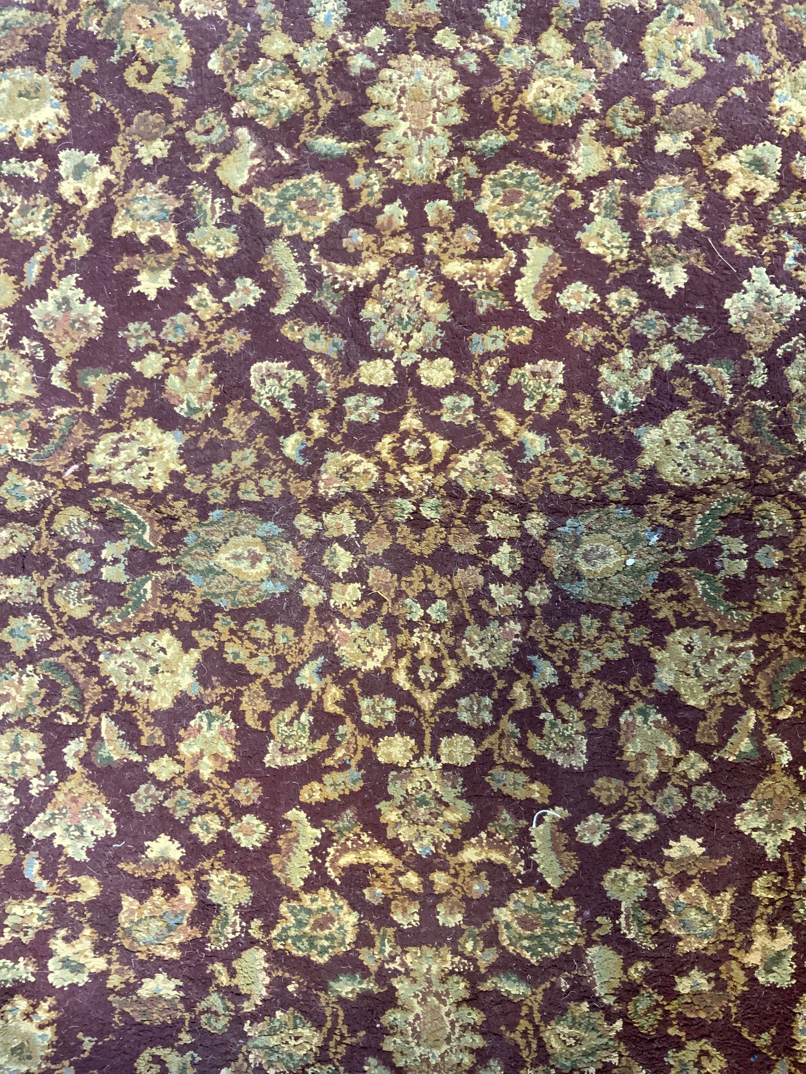 Vintage Handmade Oriental Wool Fringed Rug: Tag reads ORIENTAL WEAVERS OF AMERICA. Rug is handmade and wool. Piece is vintage with cream toned fringes. Oriental rug with floral motif detail. Piece measures approximately 69 inches long 45 inches