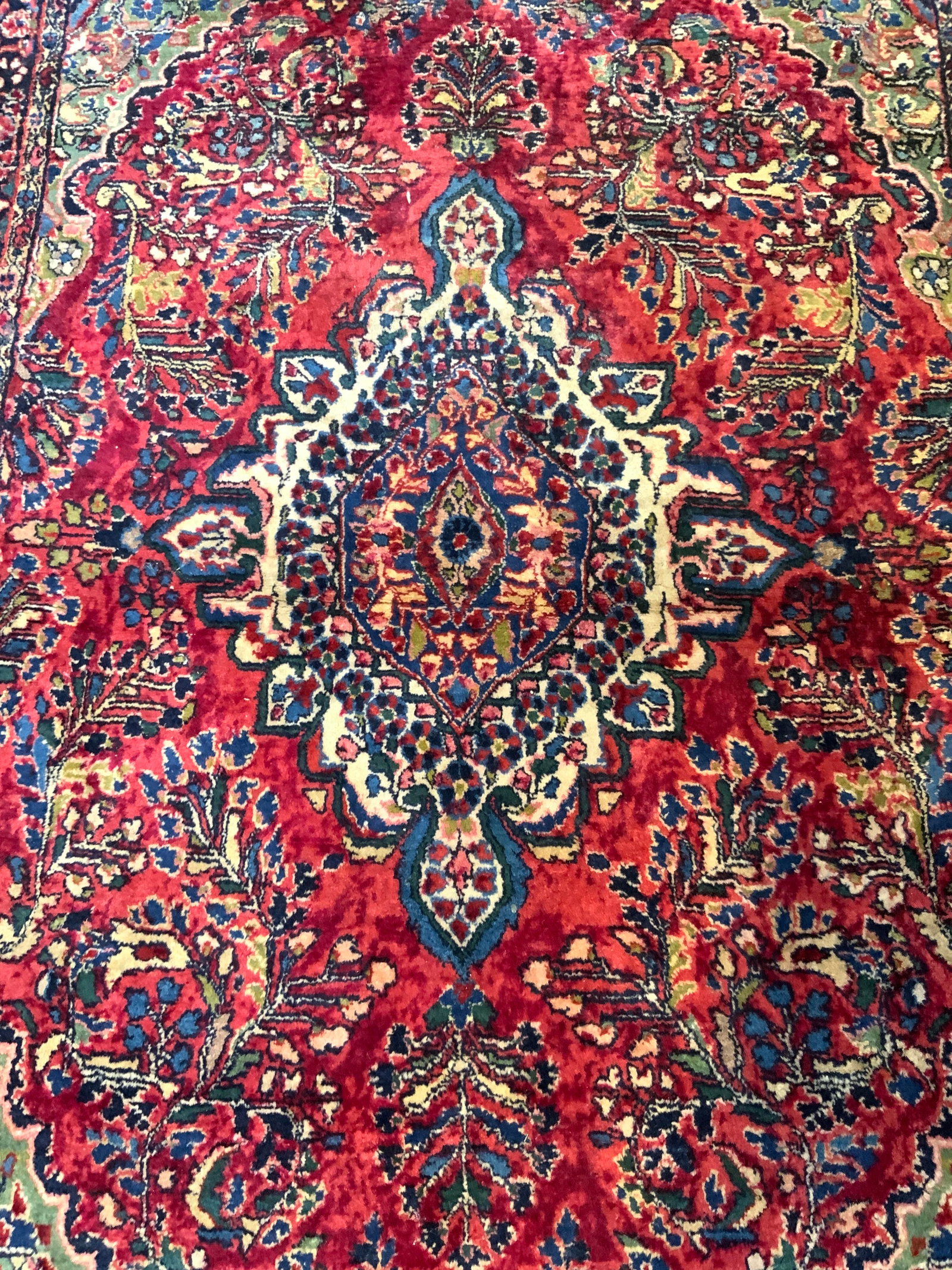 Vintage Handmade Persian Wool Area Rug: Rug is handmade and wool. Piece appears to be vintage possibly antique. Rug has intricate multi toned floral motif detail. Rug has cream toned edges 57 inches long 39 inches wide. Rug, carpet, area ru
